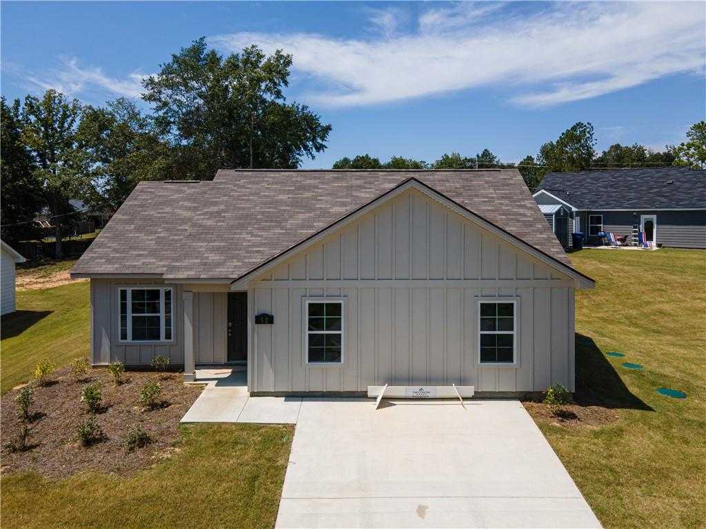 Aerial view of modern 3-bedroom single-story home with gray siding, shingled roof, driveway, and landscaped yard in Heatherbrook, Phenix City, Alabama