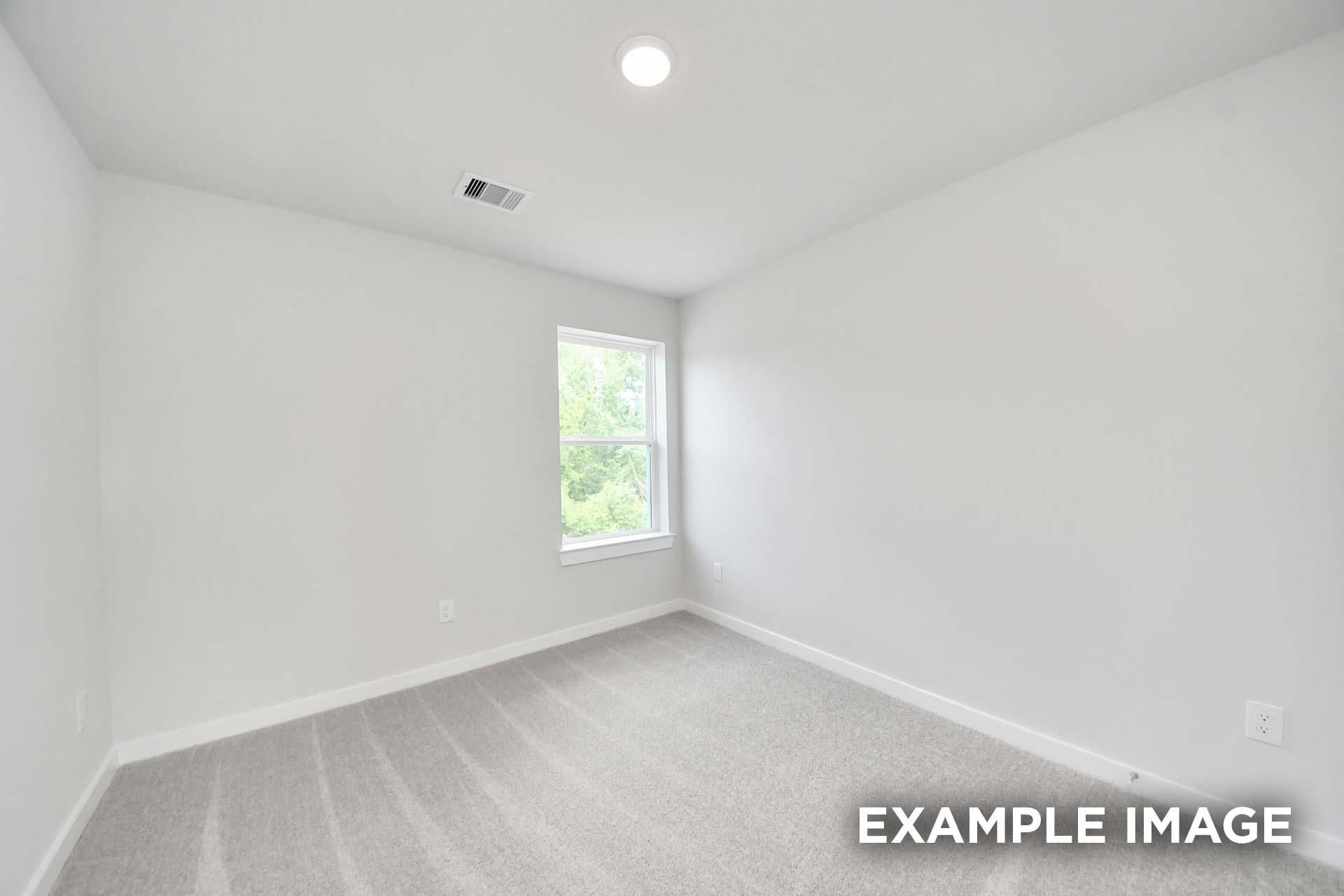 Bright empty bedroom with carpet, white walls, and window overlooking greenery in Davidson Homes The Blanco E, Windmill Estates, Magnolia, TX