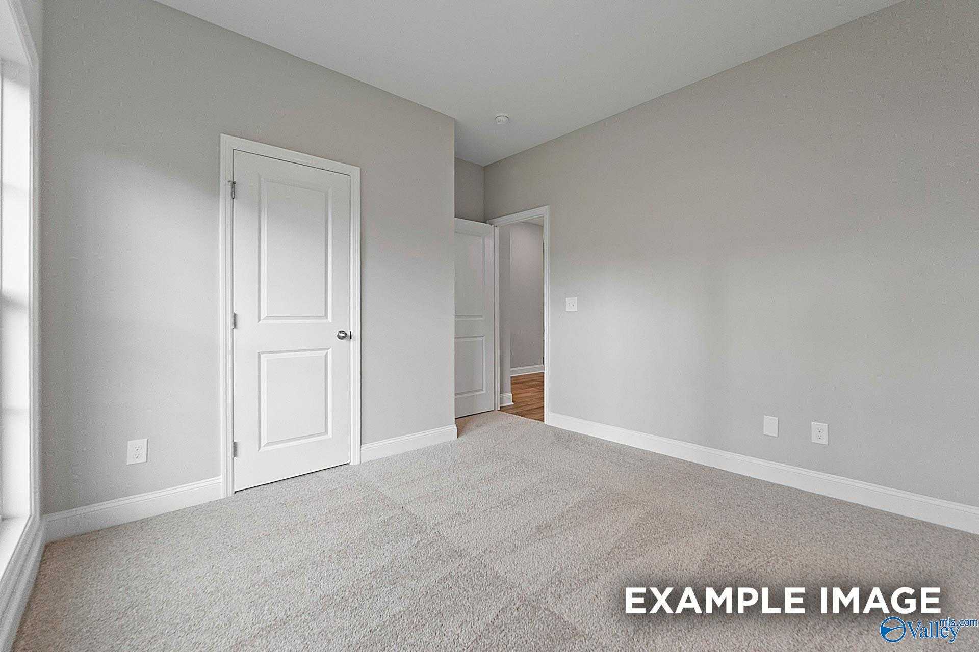 Spacious secondary bedroom with gray walls, white doors, plush carpet in Davidson Homes The Franklin E, Hazel Green AL