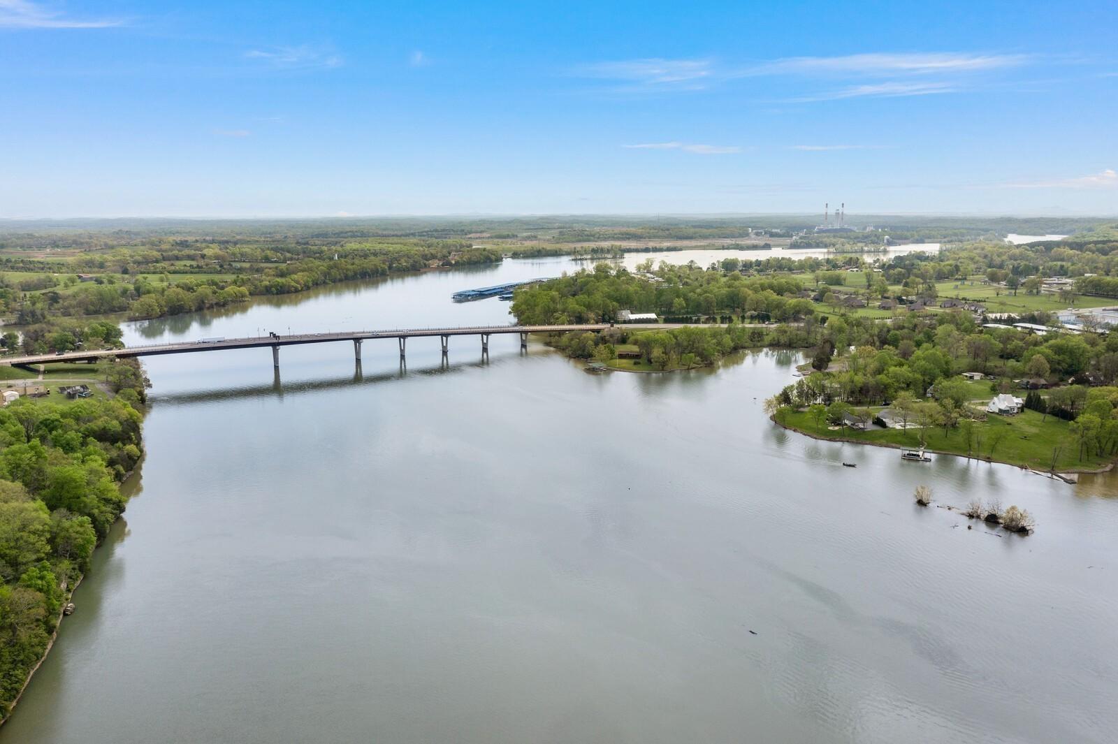 Aerial view of Cumberland River bridge spanning lush green banks and islands in Gallatin, Tennessee, near Woods Crossing Davidson Homes