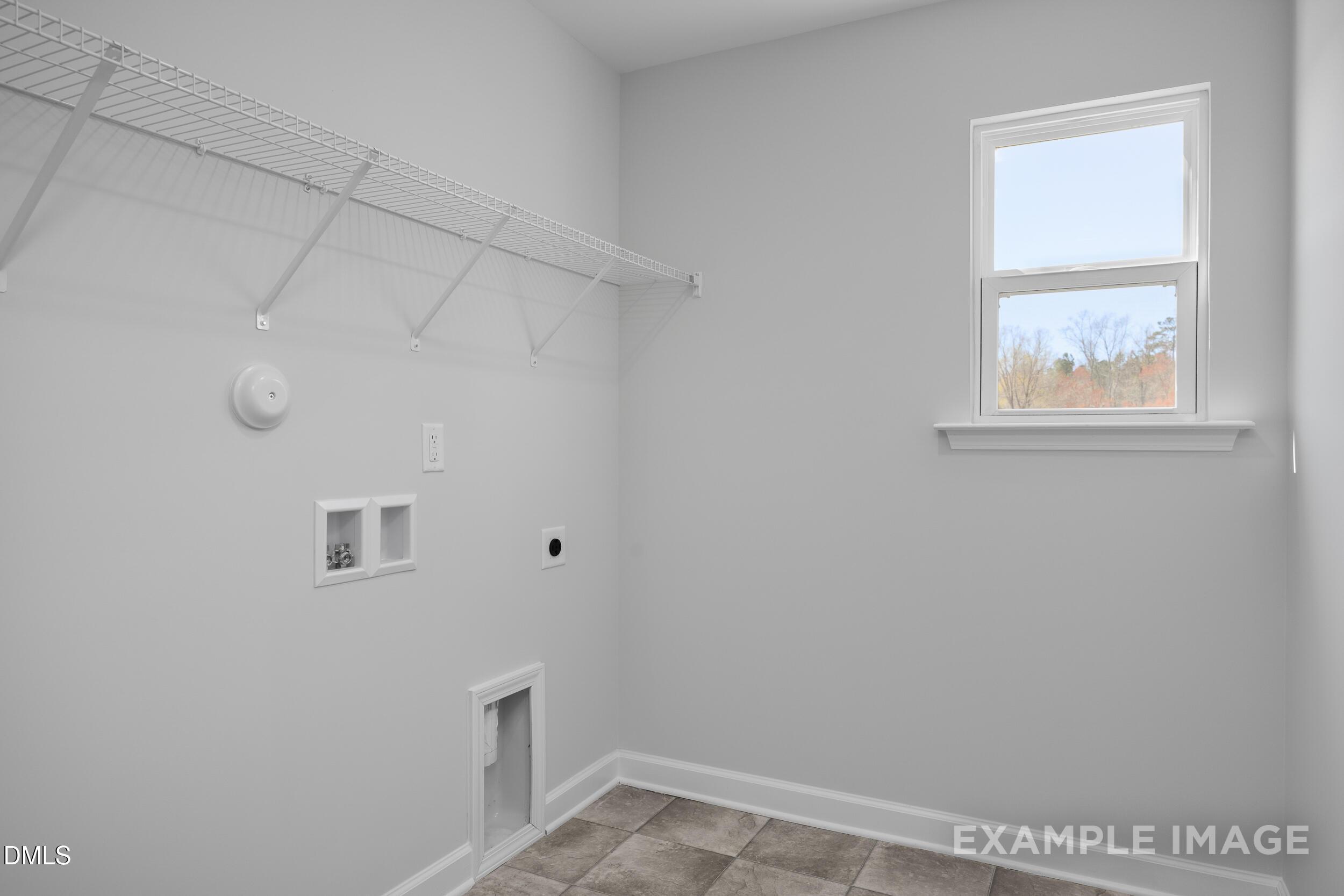 Laundry room with wire shelving and natural light in The Gavin A floor plan, Gregory Village, Lillington, North Carolina.