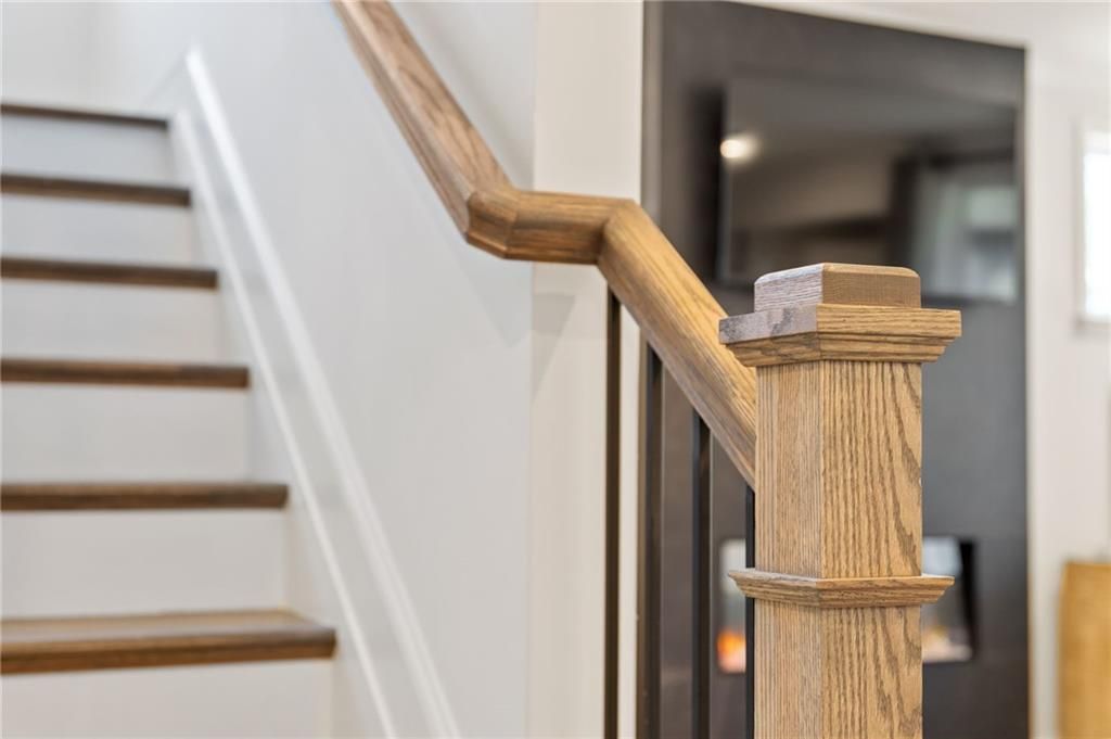Modern wooden staircase railing in The Aspen C floor plan by Davidson Homes at Fern Hollow in Buford, Georgia.