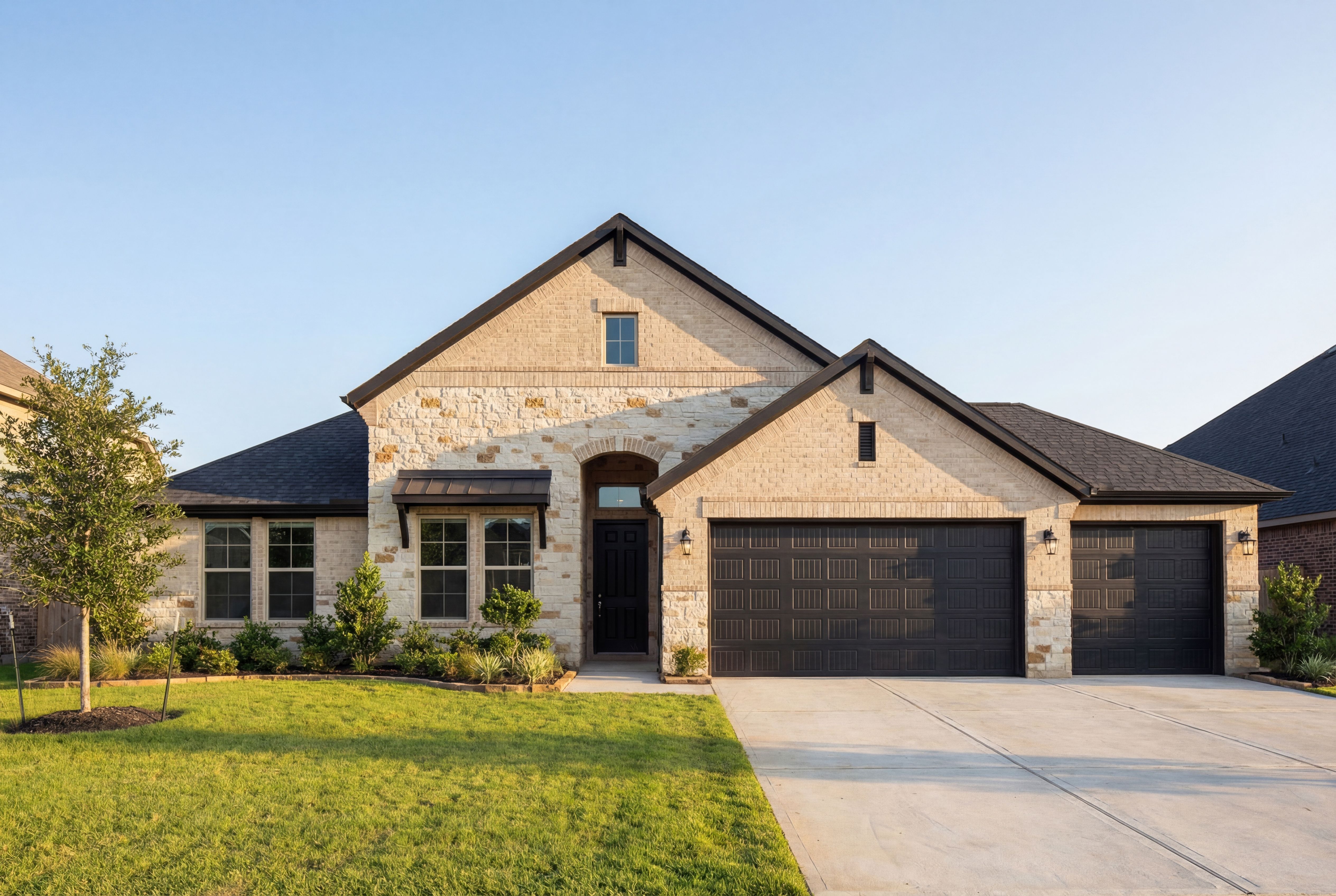 The Edward B 3-car garage home exterior featuring stone facade, beige siding, and landscaped front yard in Texas City