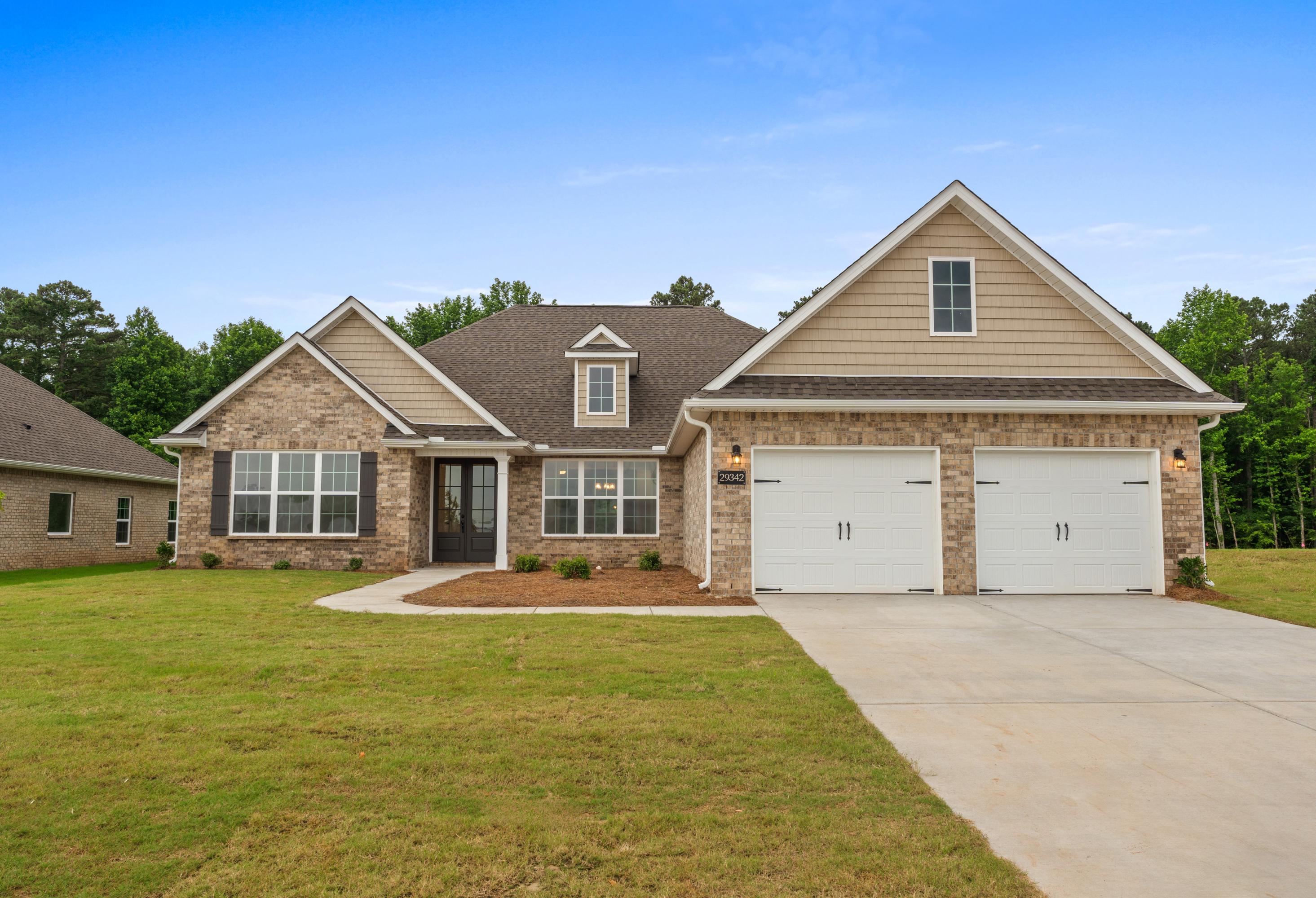Front elevation of The Oxford 4-bedroom single-story home with brick accents, siding, 2-car garage, driveway, and green lawn in Meridianville AL