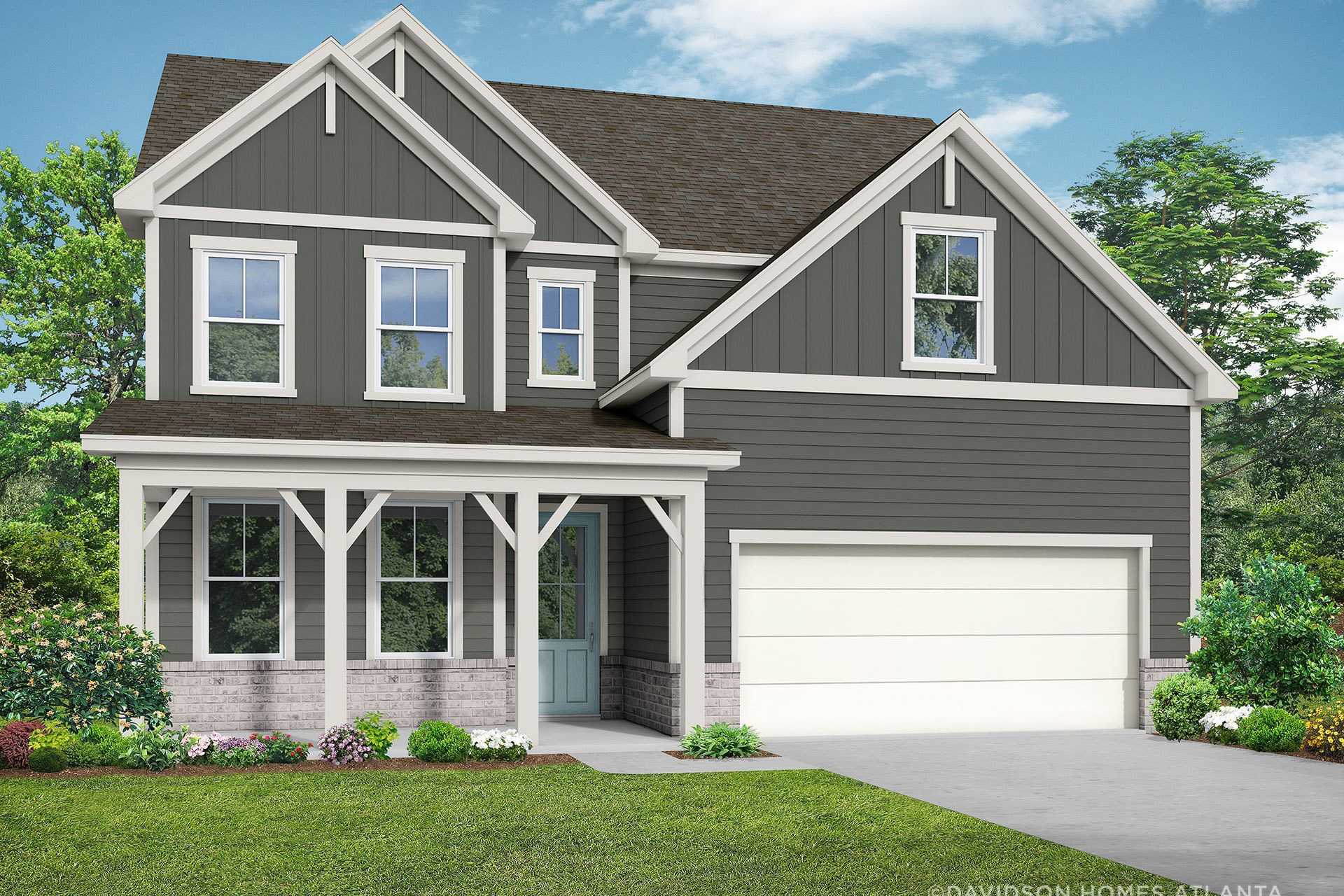 Two-story craftsman elevation of The Hickory B showcasing gray siding, covered porch, two-car garage, and lush landscaping in Hoschton