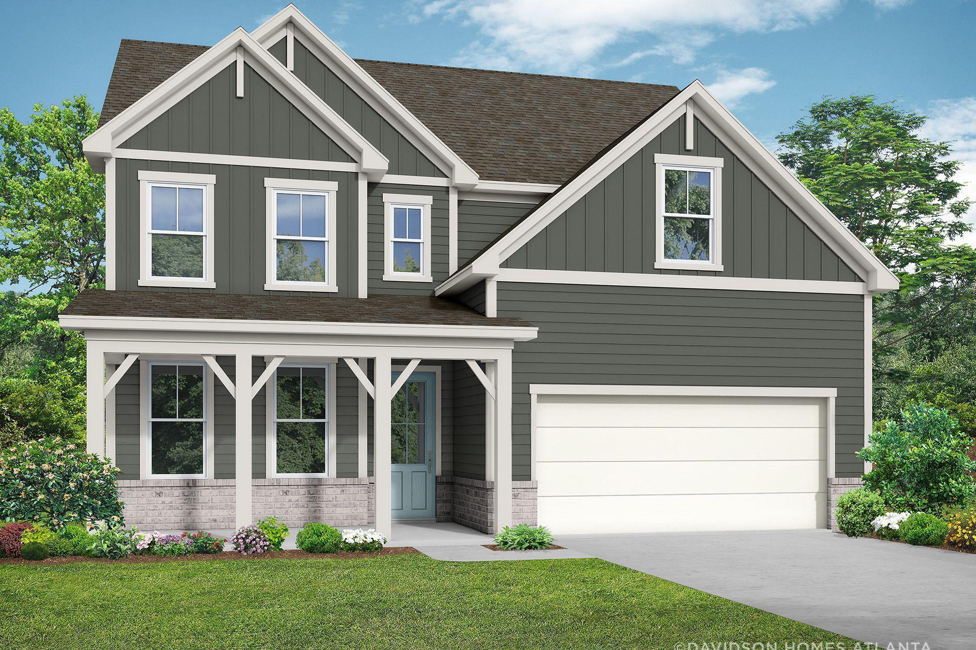 Two-story craftsman elevation of The Hickory B showcasing gray siding, covered porch, two-car garage, and lush landscaping in Hoschton