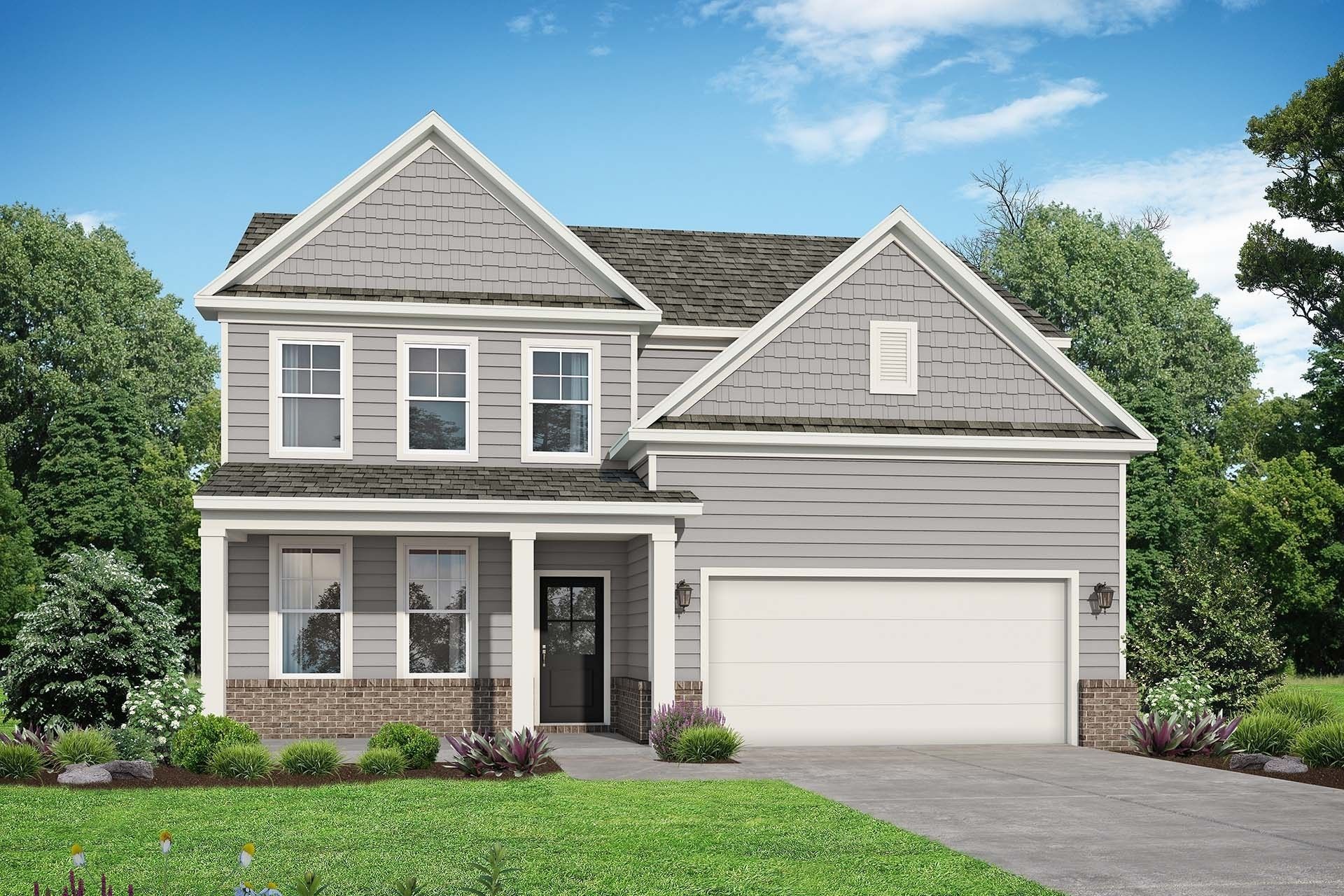 Modern two-story gray home with covered porch, two-car garage, brick accents, and lush landscaping in Calista Farms, White House, Tennessee