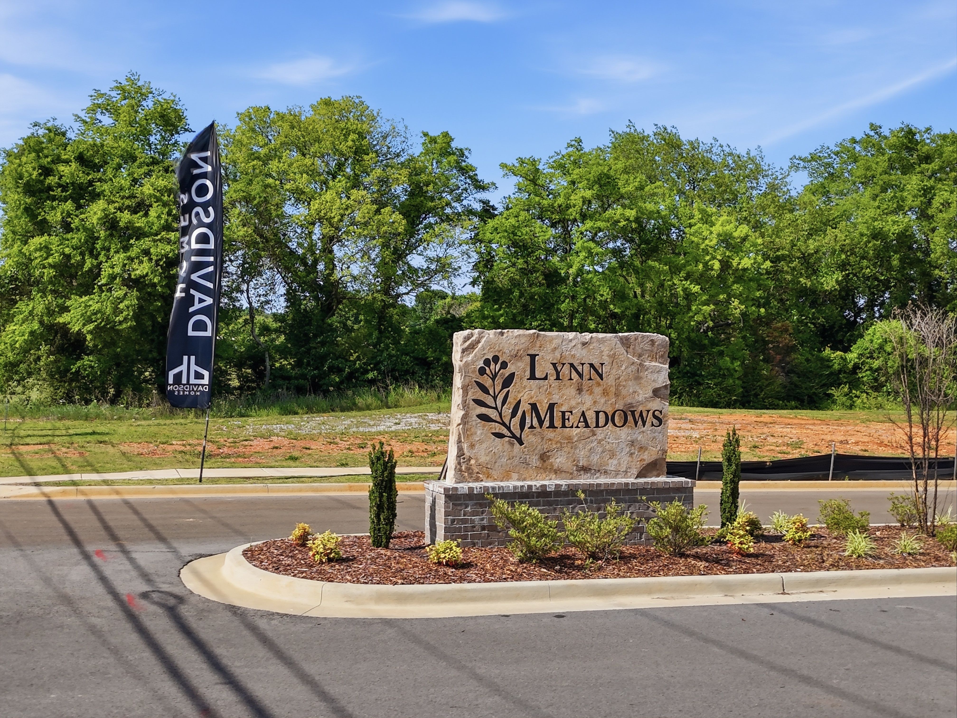 Stone entrance monument for Lynn Meadows community in Meridianville, Alabama, featuring Davidson Homes branding.