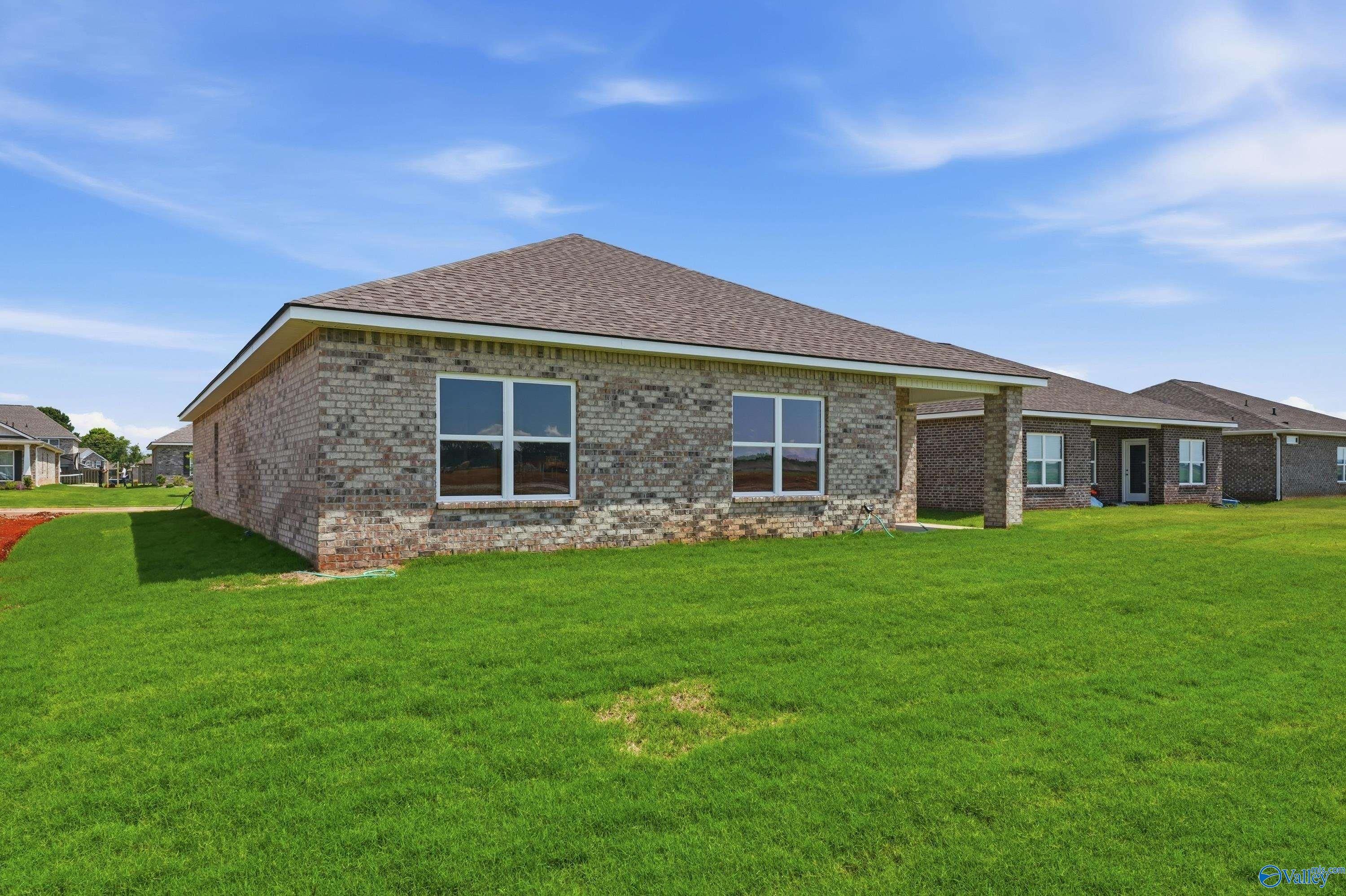 Exterior view of The Daphne floor plan by Davidson Homes in Clearview, Hazel Green, Alabama with a spacious backyard.