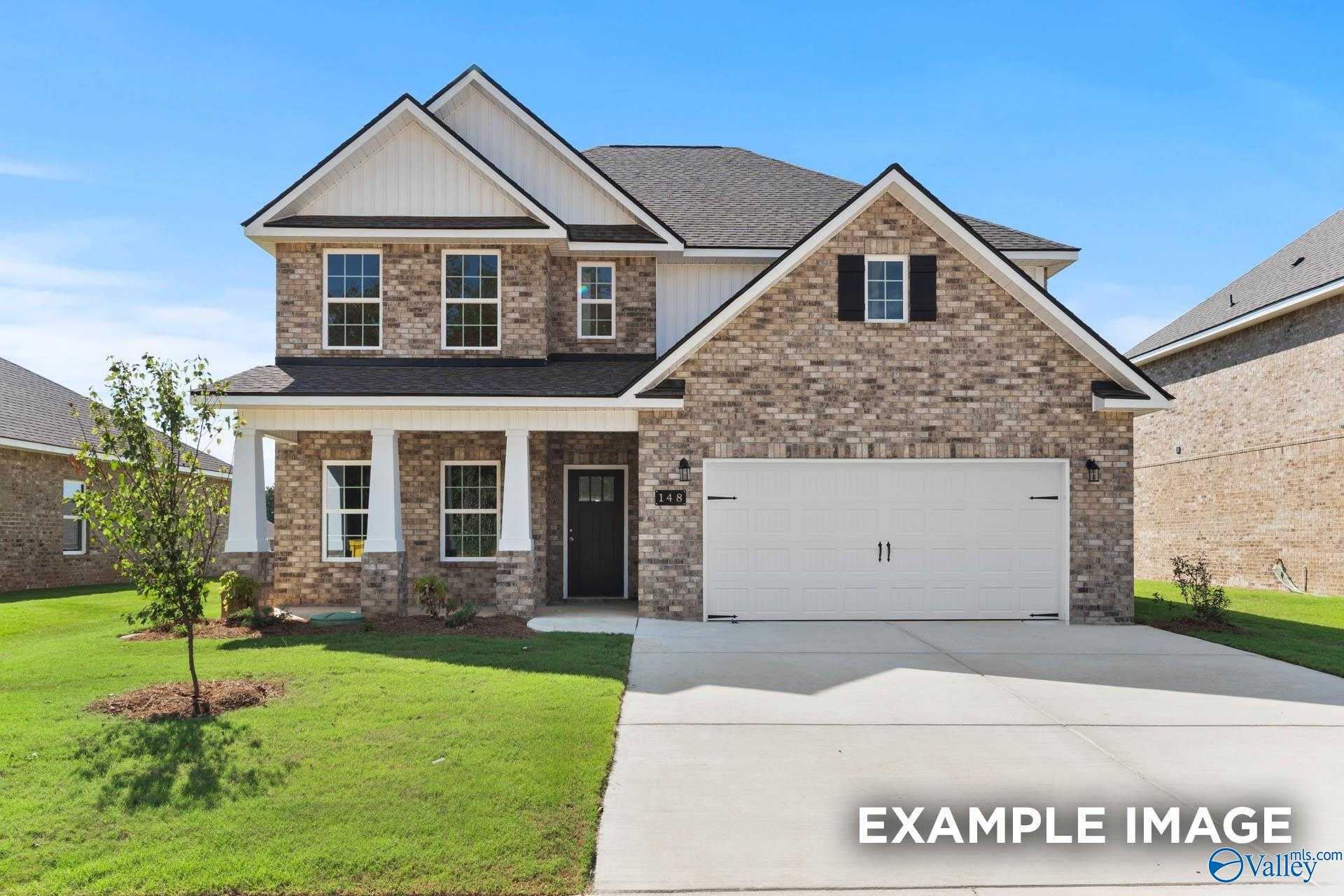 Two-story brick home with front porch, two-car garage, and lush lawn in The Meadows, Athens, Alabama – Davidson Homes Chelsea C