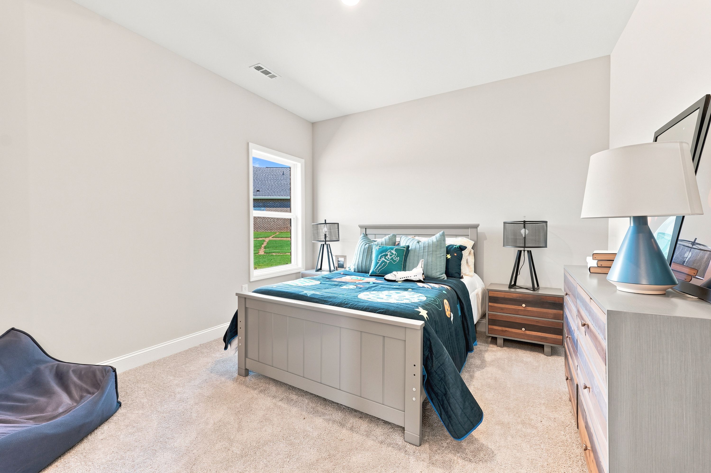 Spacious bedroom with space-themed bedding at Riverton Preserve in Huntsville, AL, built by Davidson Homes.