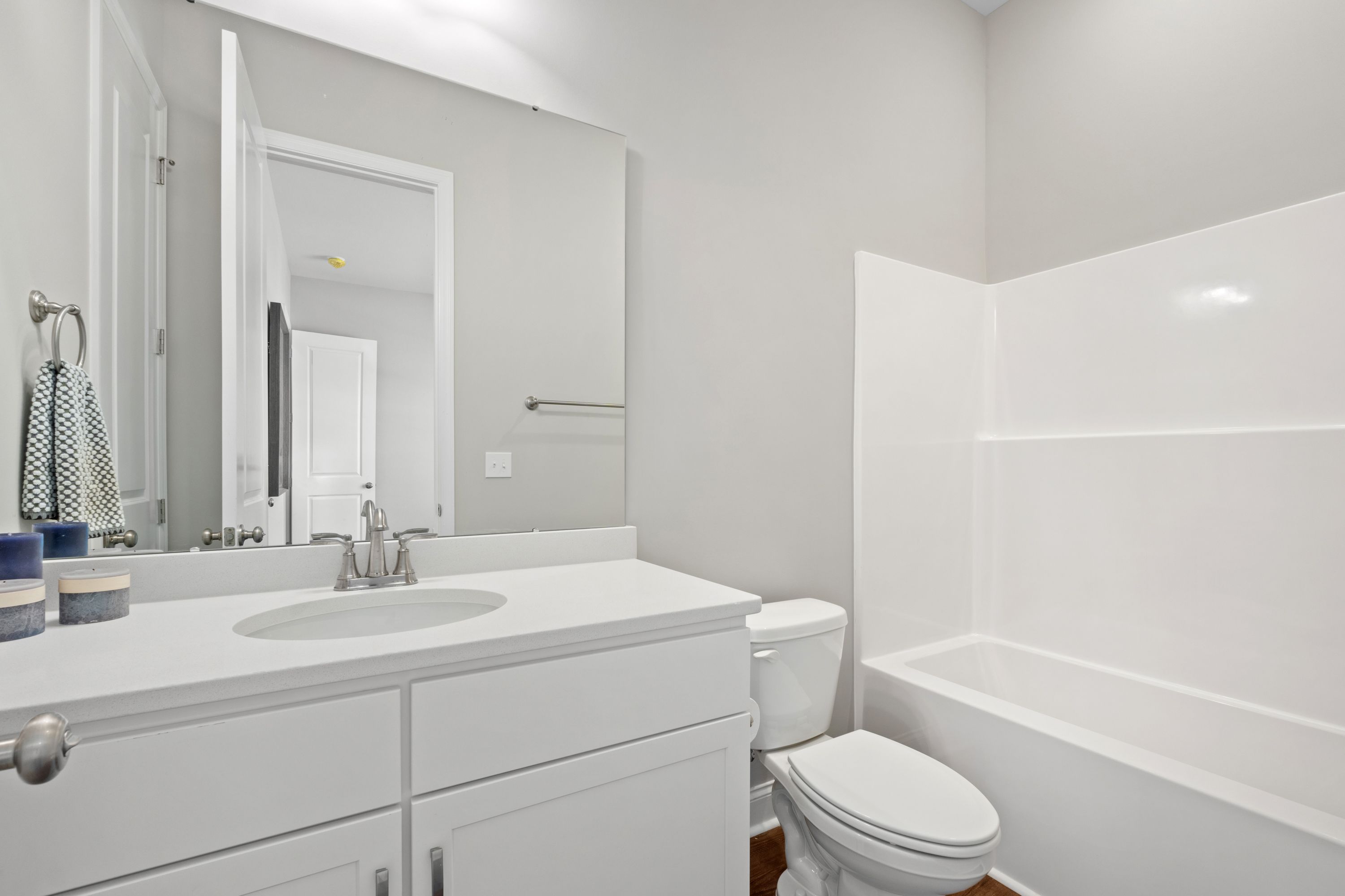 Spacious master bathroom in The Haven D with white double vanity, soaking tub, walk-in shower, and gray walls