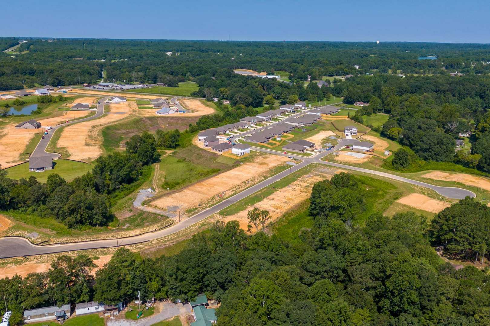 Aerial view of developing neighborhood with new homes, wooded lots, and ponds at The Reserve at North Ridge in Cullman Alabama