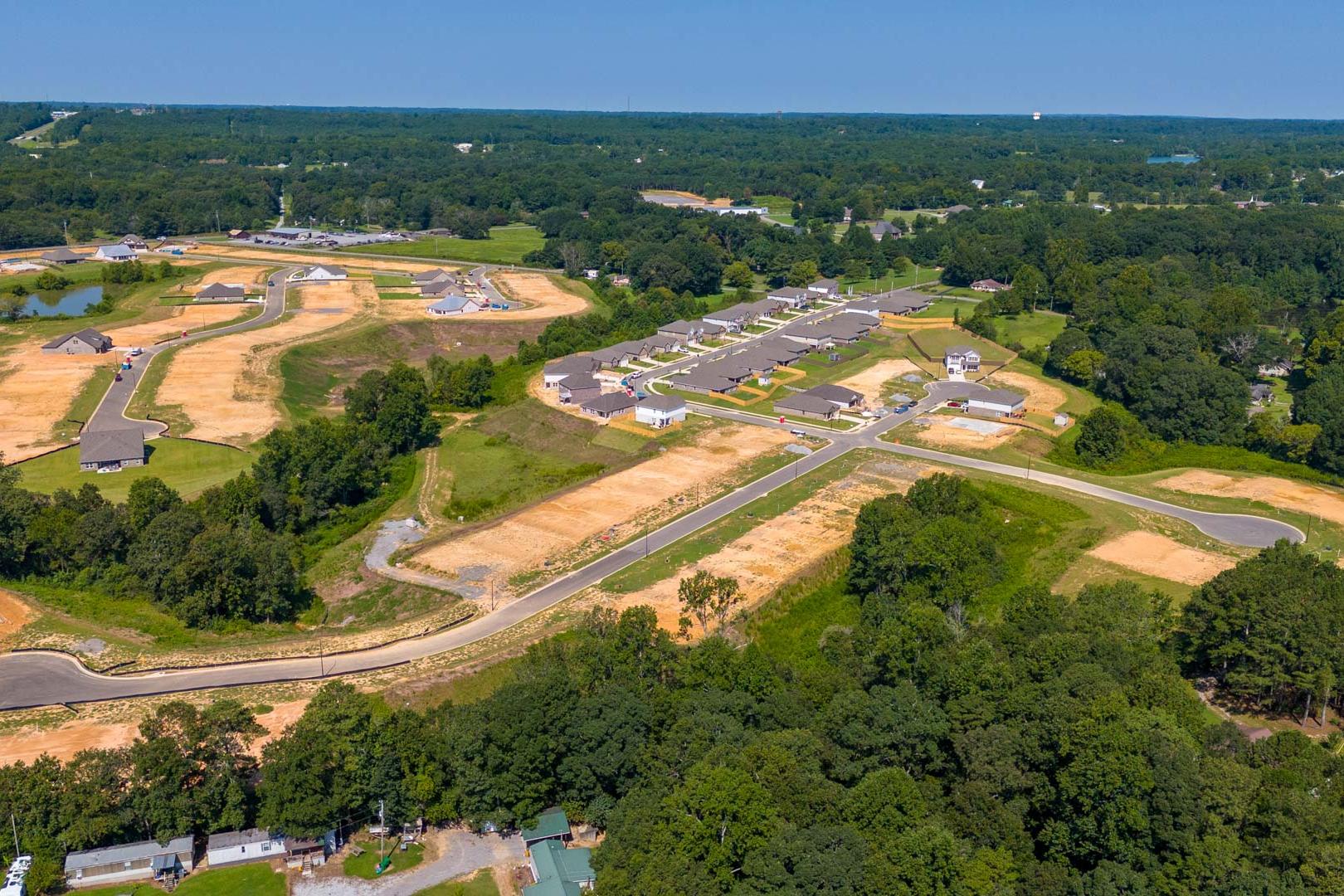 Aerial view of developing neighborhood with new homes, wooded lots, and ponds at The Reserve at North Ridge in Cullman Alabama