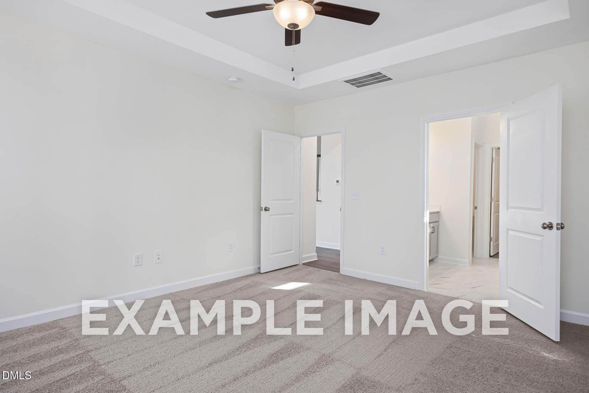 Spacious master bedroom with ceiling fan and open en-suite bathroom in Davidson Homes The Ash B, Zebulon, NC