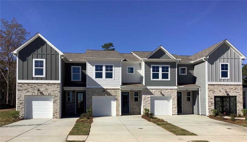 Modern 3-bedroom two-story townhomes with gray siding, garages, and driveways in Stegall Village, Emerson, Georgia by Davidson Homes Wilmington B