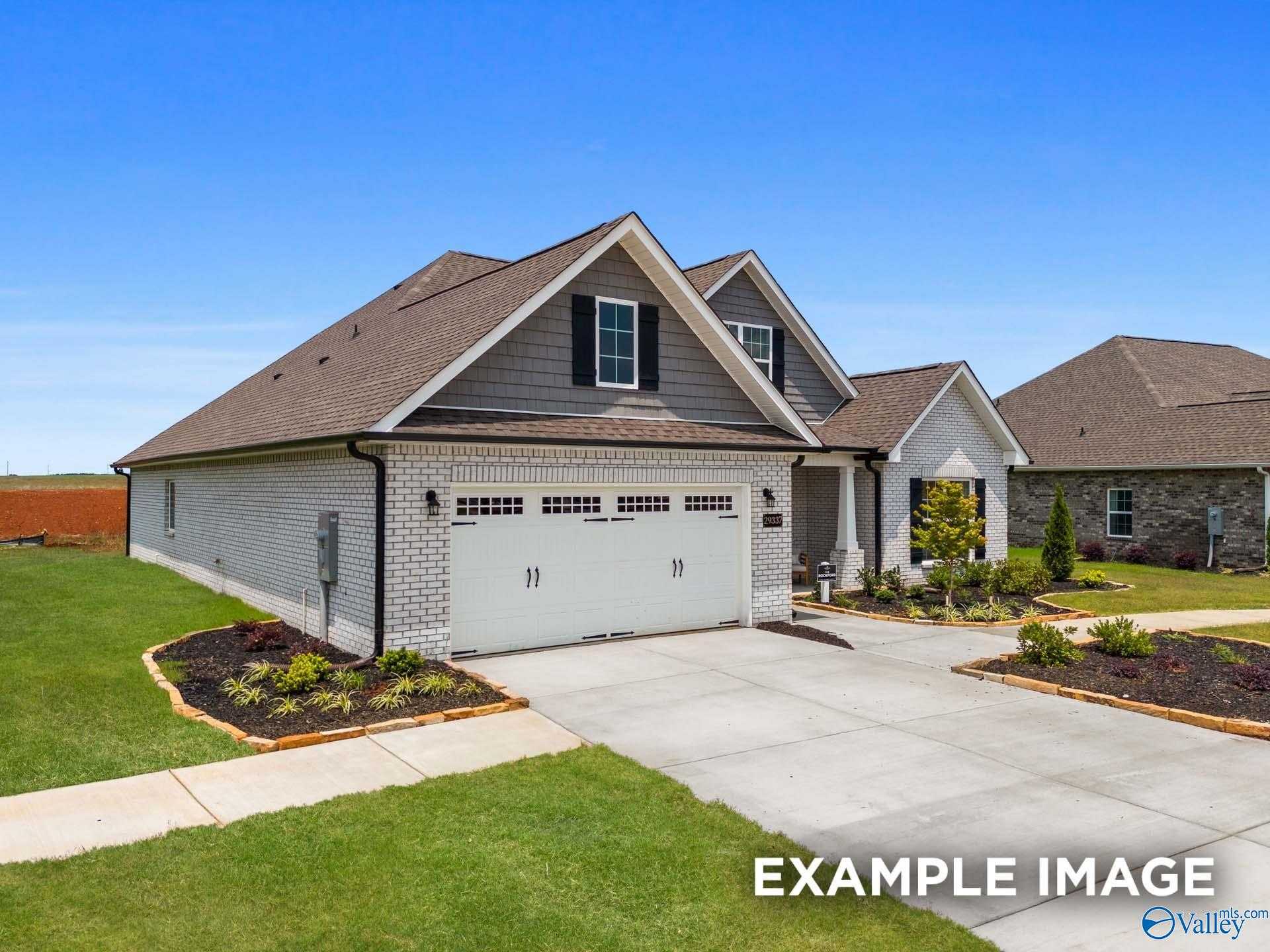 Modern single-story brick home with 2-car garage, shingled roof, and landscaped front yard in Cain Park, Hartselle, Alabama - The Rockford B by Davidson Homes