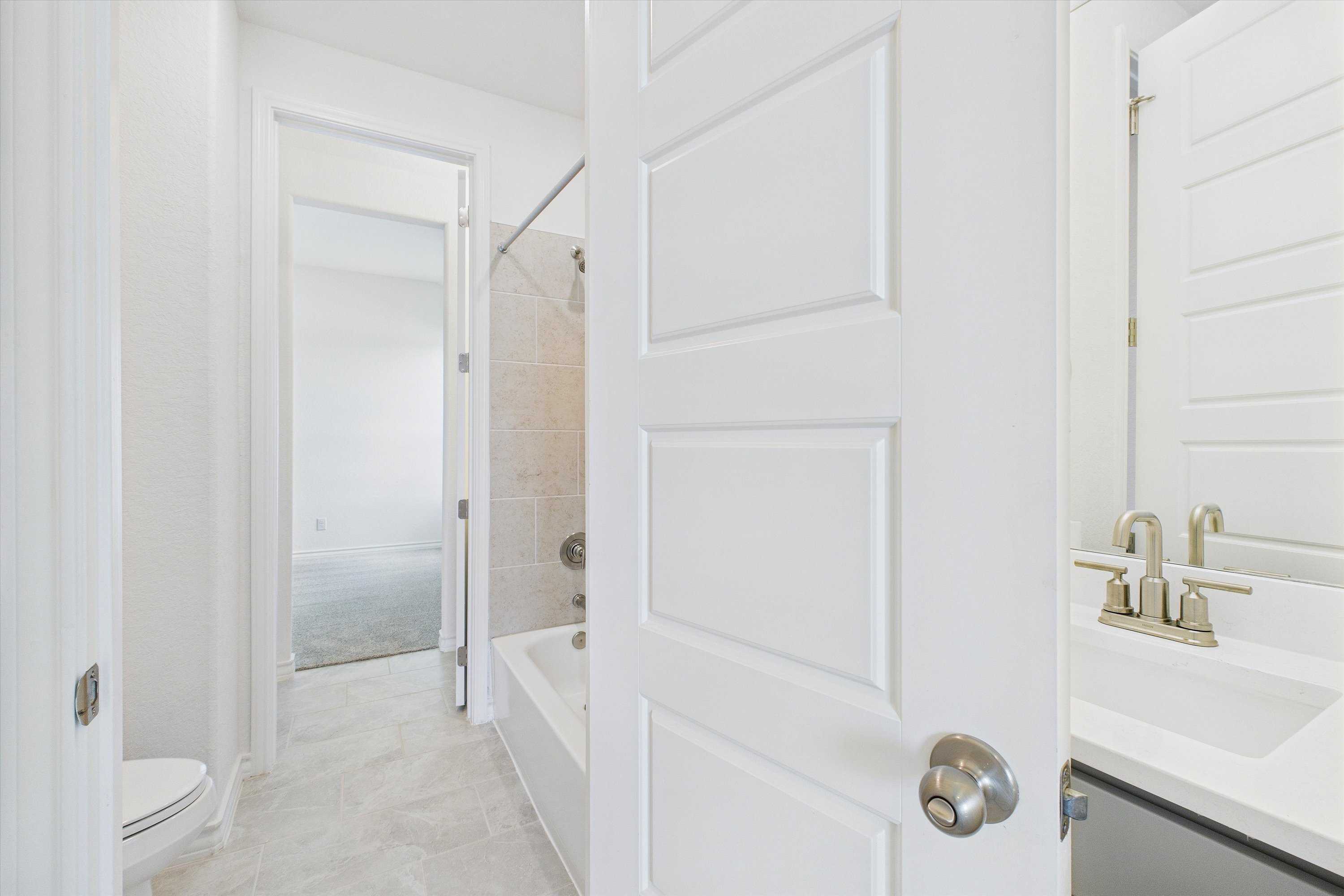 Spacious bathroom with soaking tub, walk-in shower, and modern vanity in The Summerlin C 4-bedroom home by Davidson Homes, Castroville, Texas
