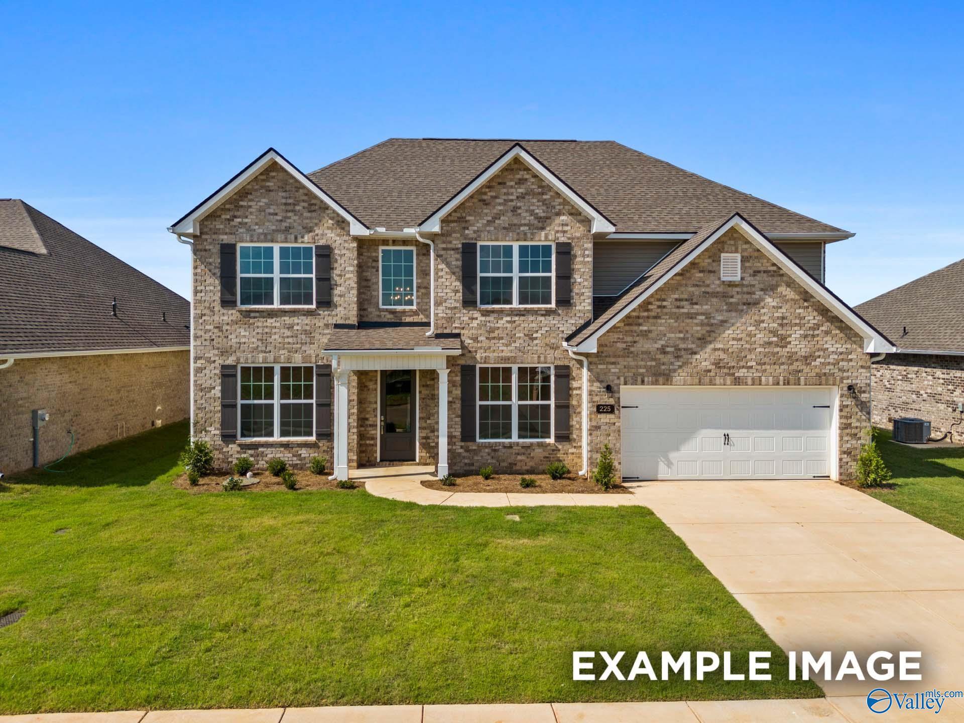 Modern brick 1.5-story home with white shutters, 2-car garage, and manicured lawn in Kendall Downs, Toney, Alabama - Davidson Homes Madison A