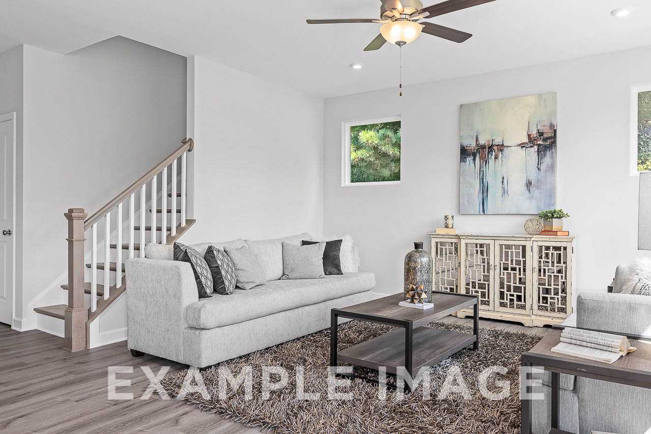 Davidson Homes the Chestnut Plan Living Area with couches, side tables, coffee table, and decor