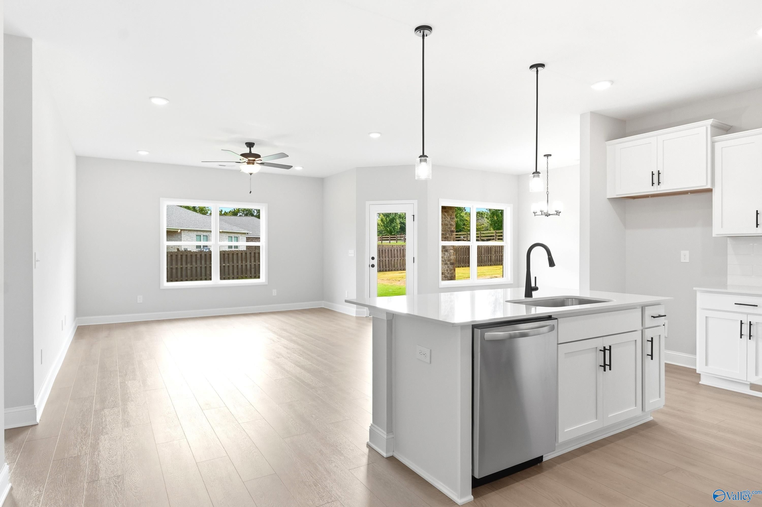Open-concept kitchen and living area in The Daphne C floor plan at Flint Meadows, New Market, Alabama.