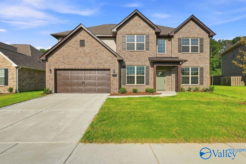 Two-story brick home, The Madison A floor plan by Davidson Homes, in Cain Park, Hartselle, Alabama with 2-car garage.