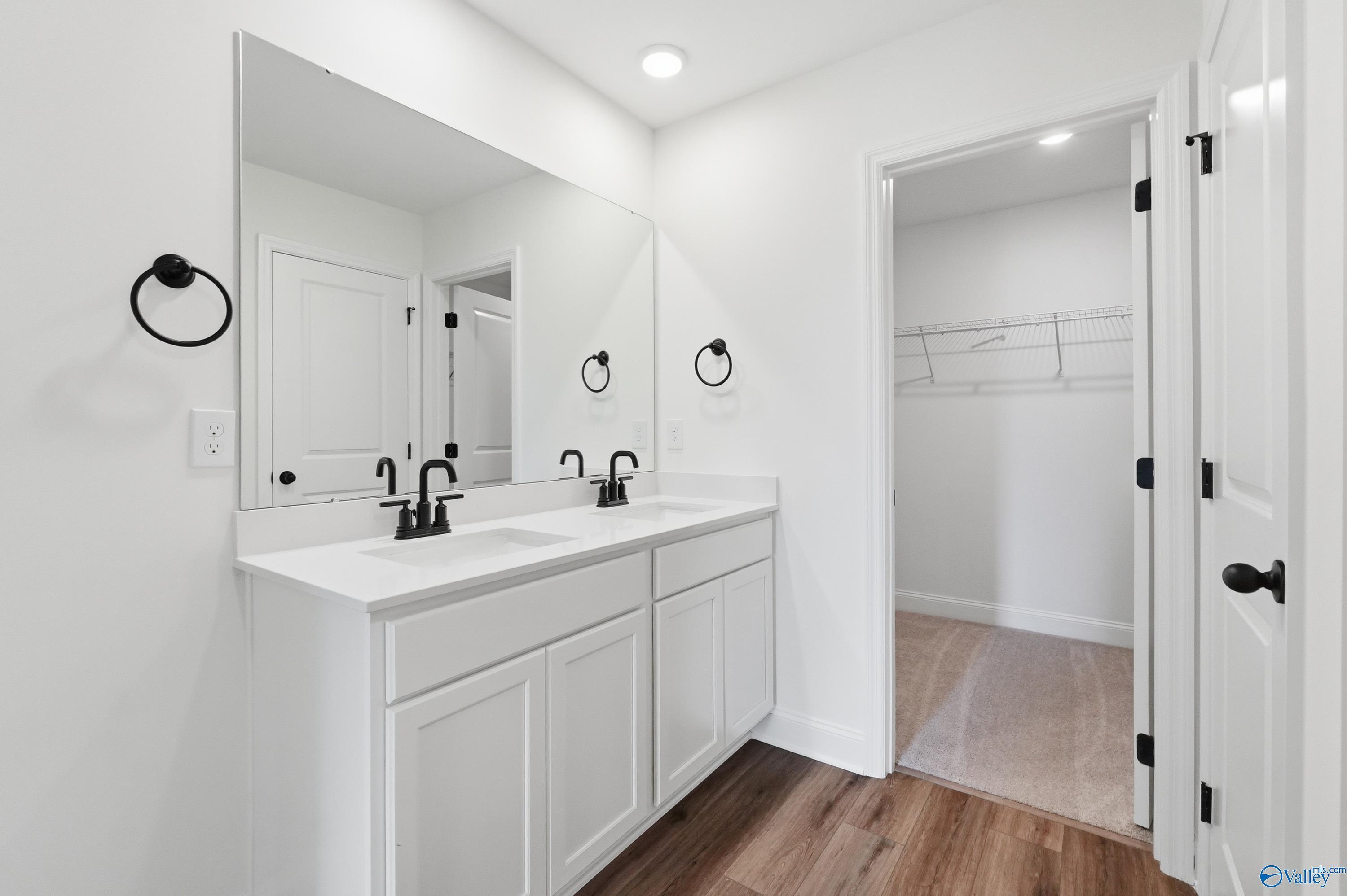 Modern master bathroom with dual vanity and walk-in closet in The Franklin floor plan at Heritage Lakes, New Market, AL.