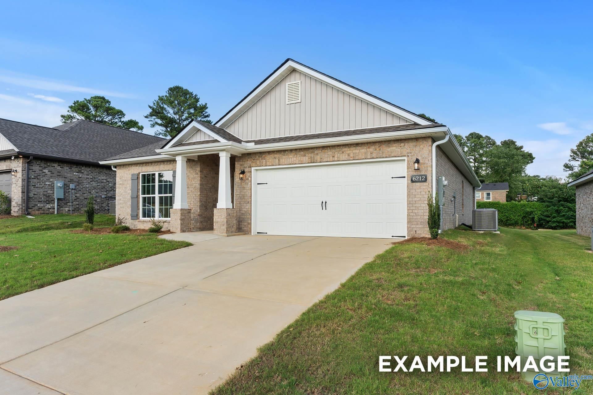 Modern 4-bedroom single-story home with brick siding, two-car garage, and driveway in Ivy Hills, Toney, Alabama by Davidson Homes