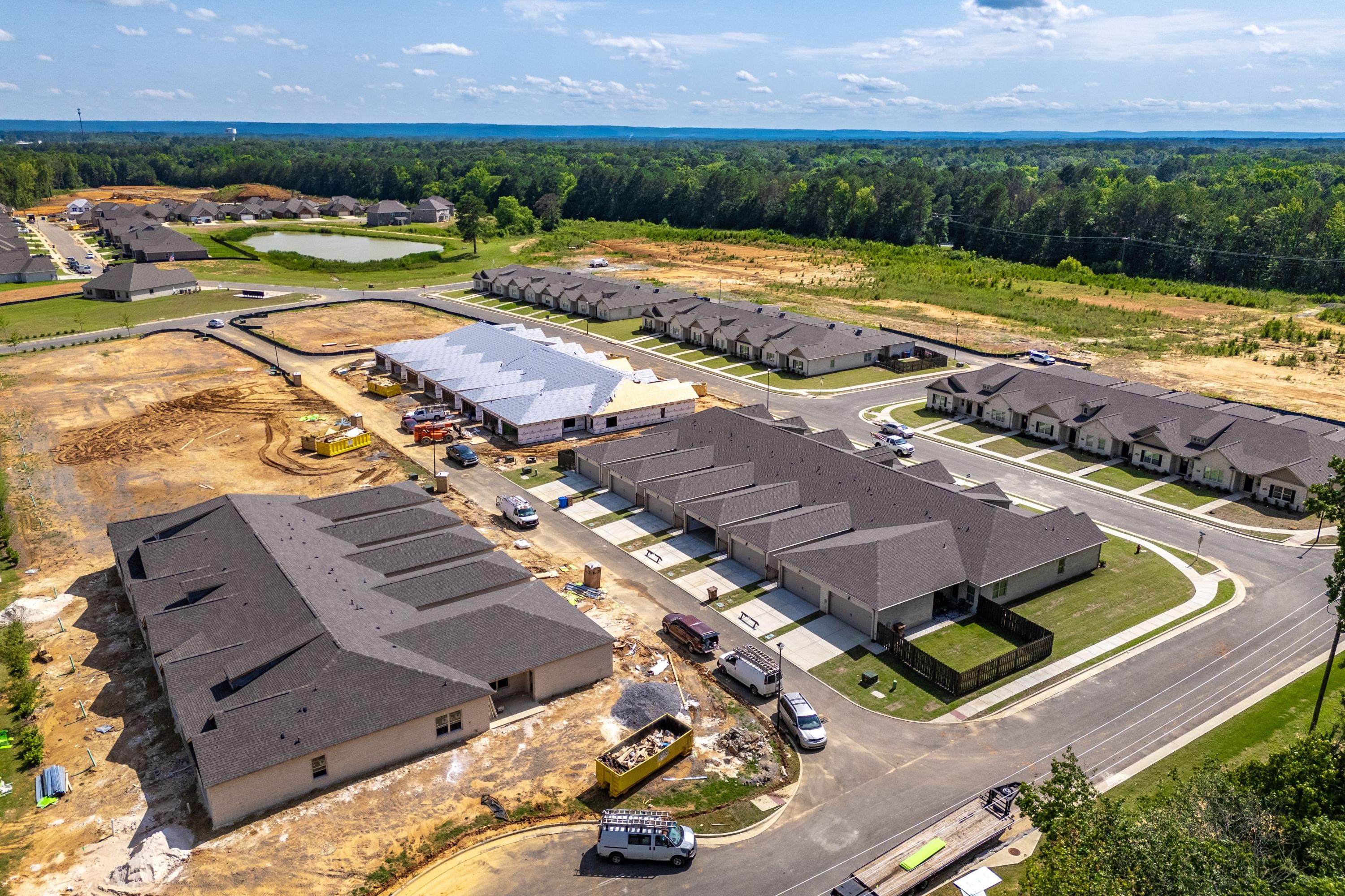 Aerial view of townhomes under construction at The Retreat at Cain Park in Hartselle Alabama amid green fields