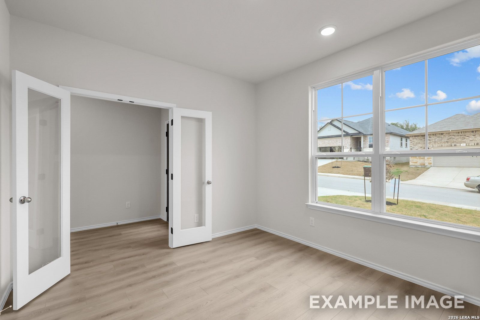 Bright home office with French doors and large windows in The Sequoia C floor plan at Royal Crest, San Antonio.