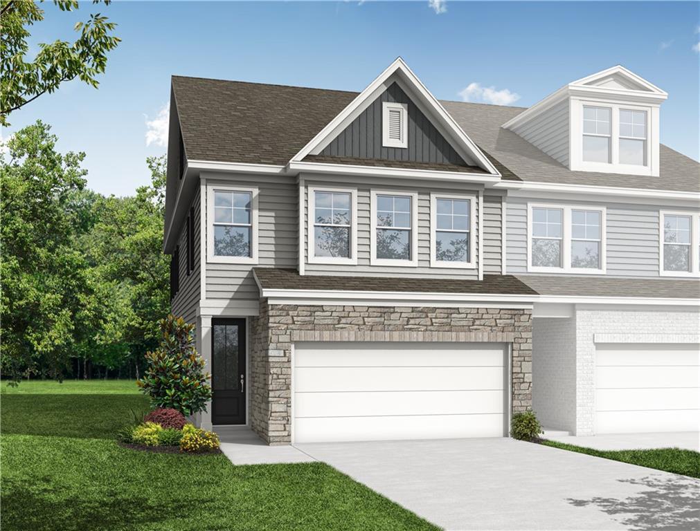 Two-story Durham D floor plan by Davidson Homes with stone facade and two-car garage in Hemingway, Cumming, GA.