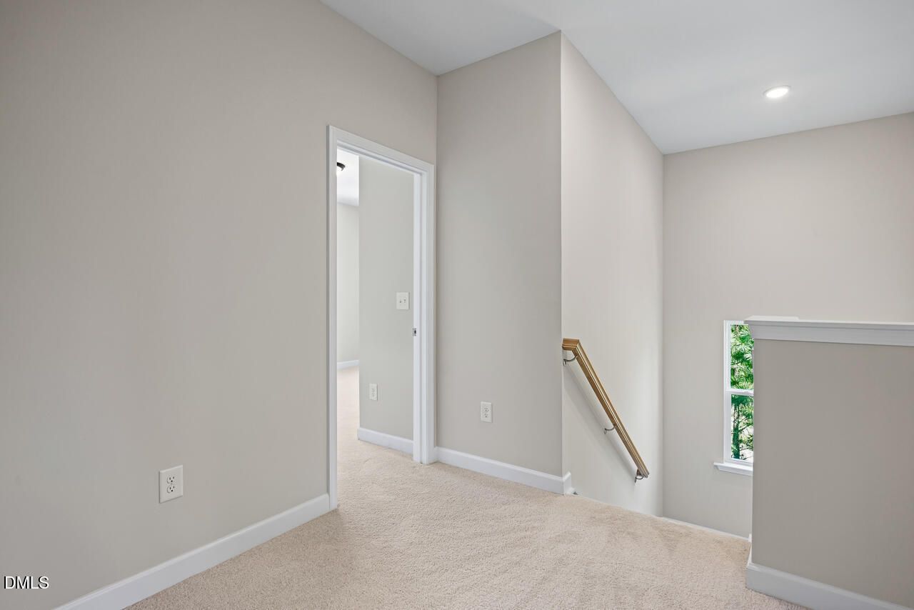 Bright second-floor landing with carpeted hallway in The Chestnut floor plan at Montrose, Aberdeen, North Carolina.