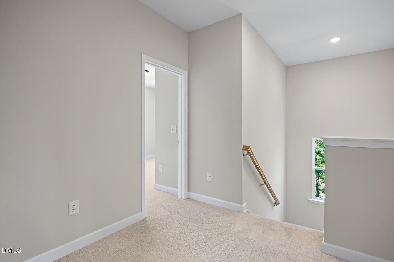 Bright second-floor landing with carpeted hallway in The Chestnut floor plan at Montrose, Aberdeen, North Carolina.