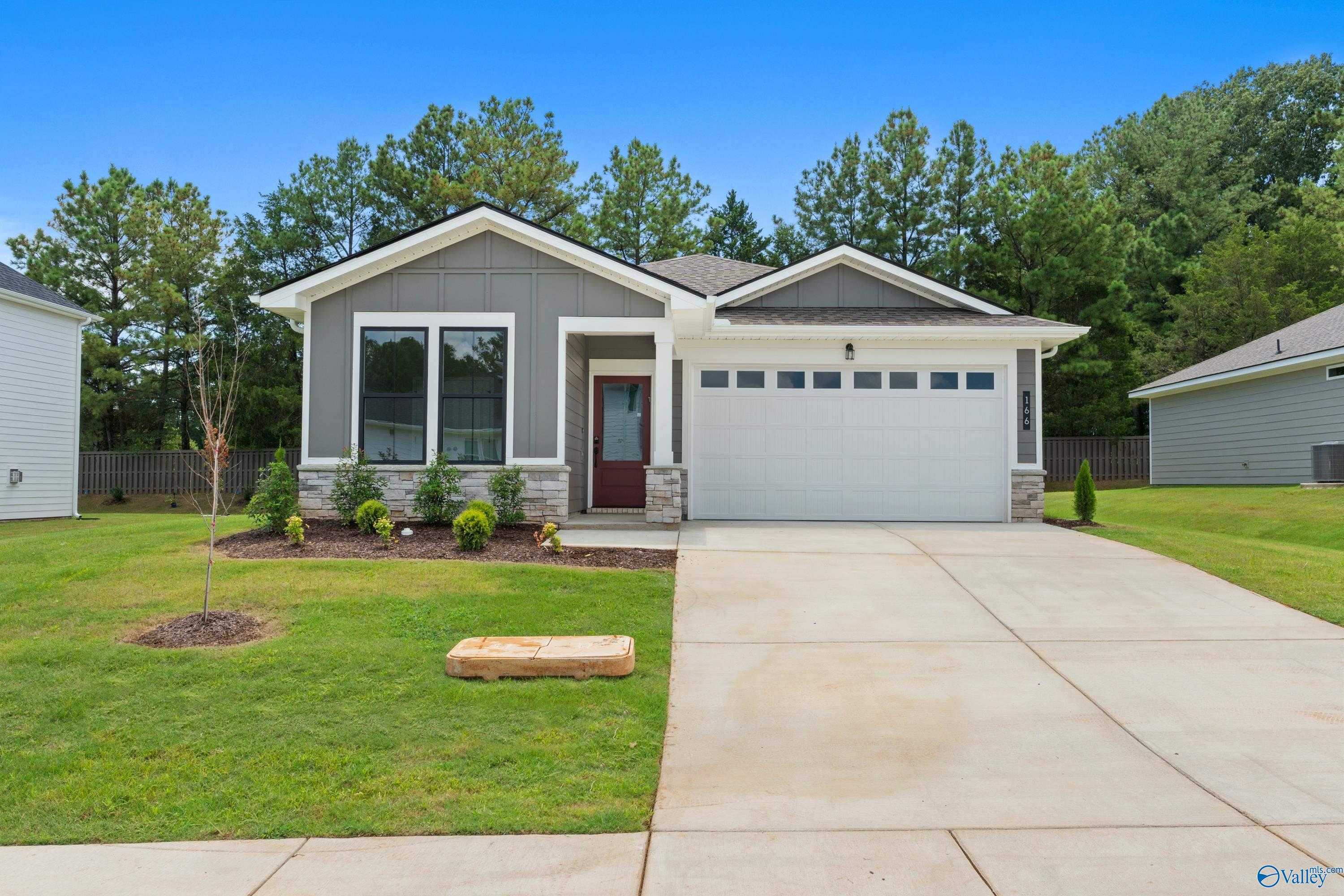Modern gray 1-story Nantucket home by Evermore Homes with 2-car garage, large windows, and landscaped yard in Evergreen Mill, Madison, Alabama