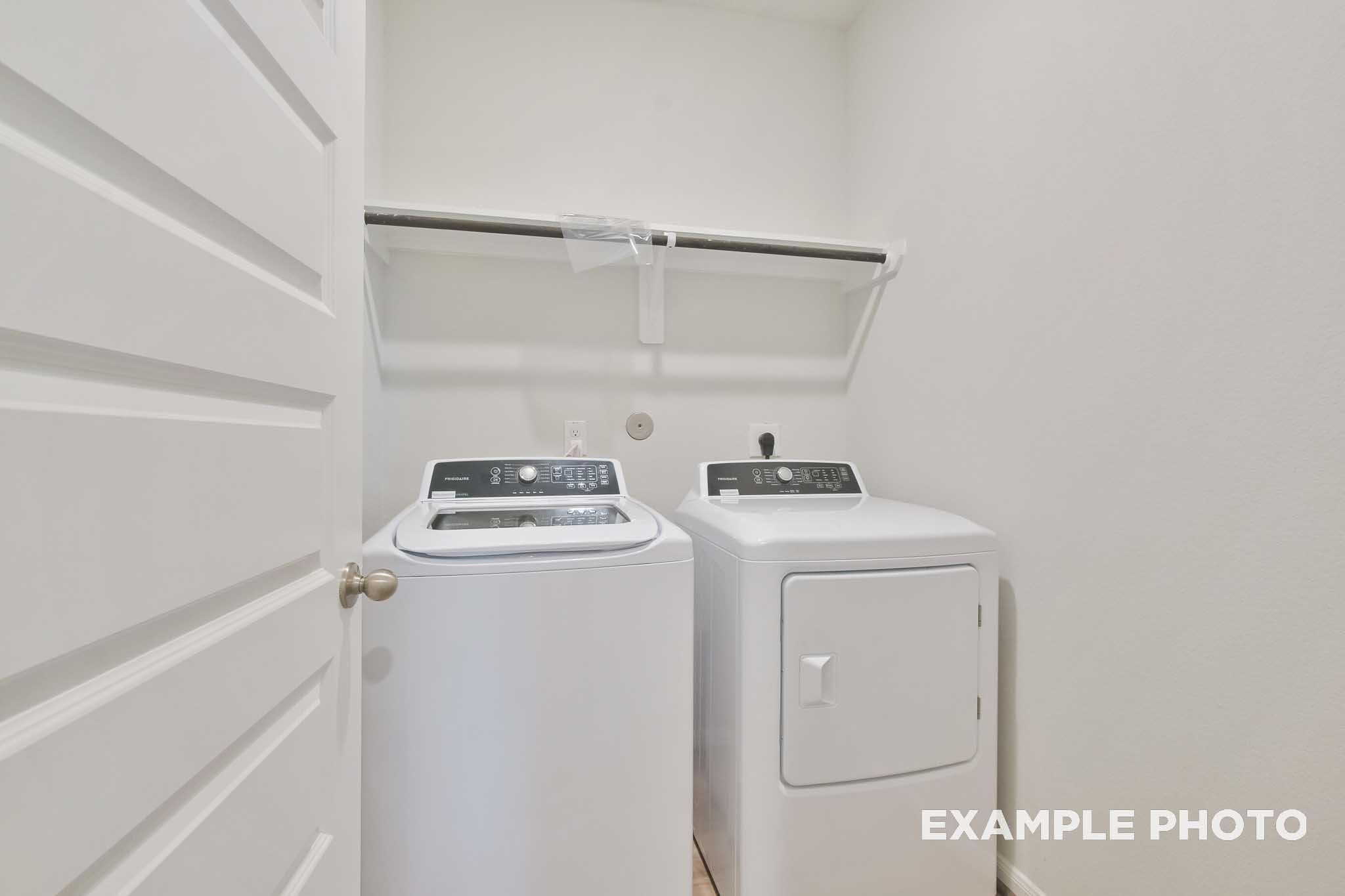 Dedicated laundry room with washer and dryer in The Brazos, a Davidson Homes single-family home in Beasley, Texas