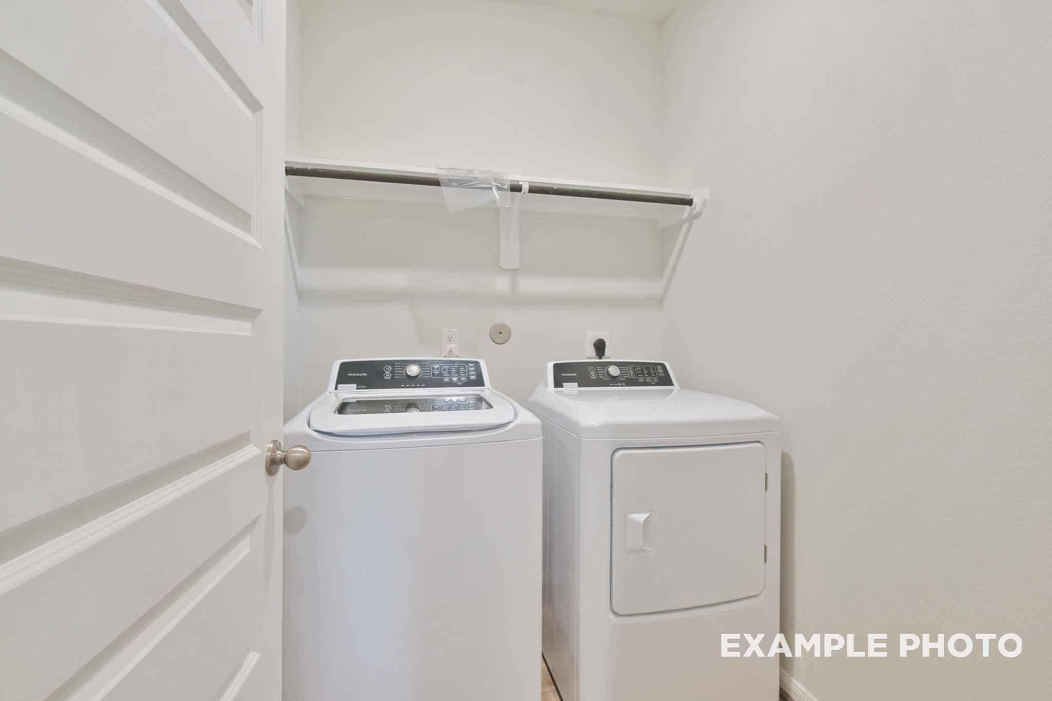 Dedicated laundry room with washer and dryer in The Brazos, a Davidson Homes single-family home in Beasley, Texas