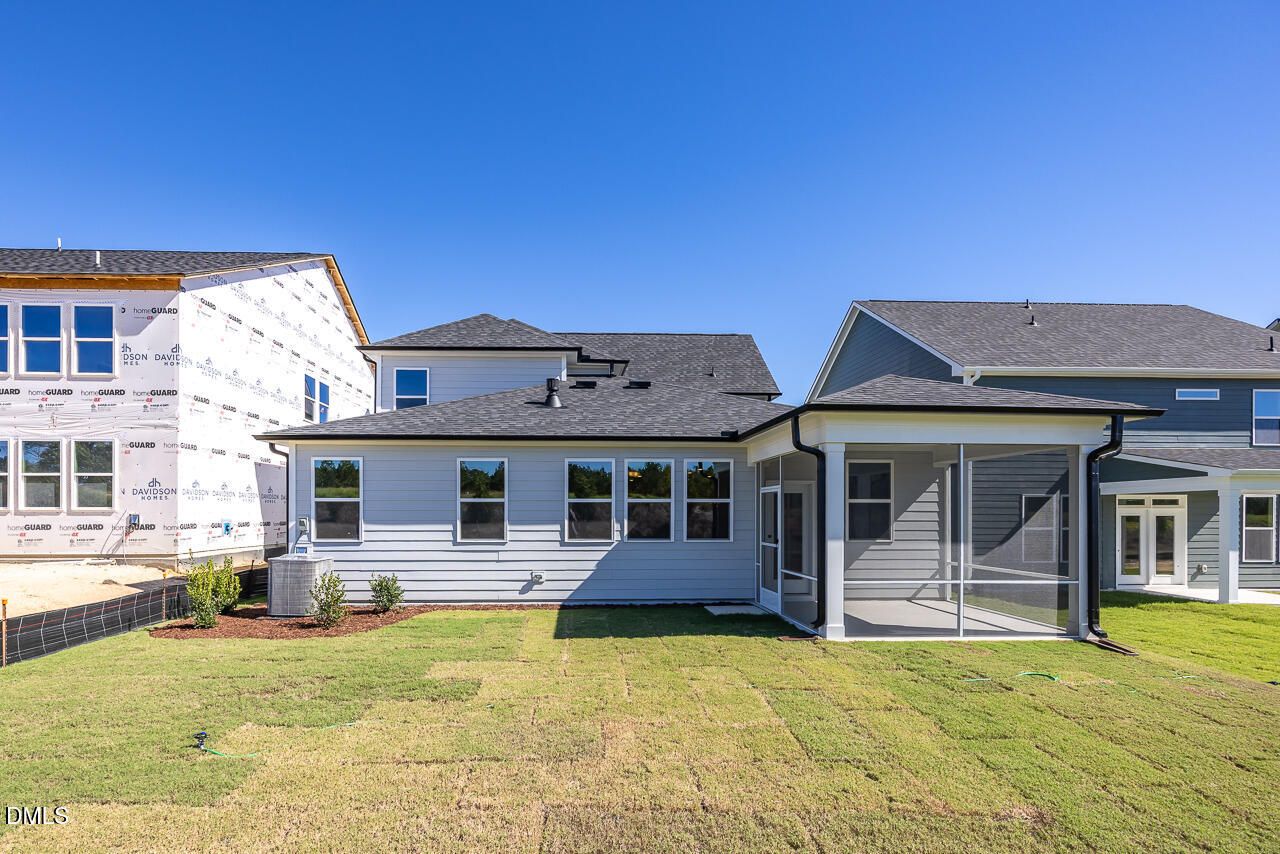 Rear exterior of Davidson Homes' The Ashport M with screened porch and fenced backyard in Wendell Ridge, Wendell, NC