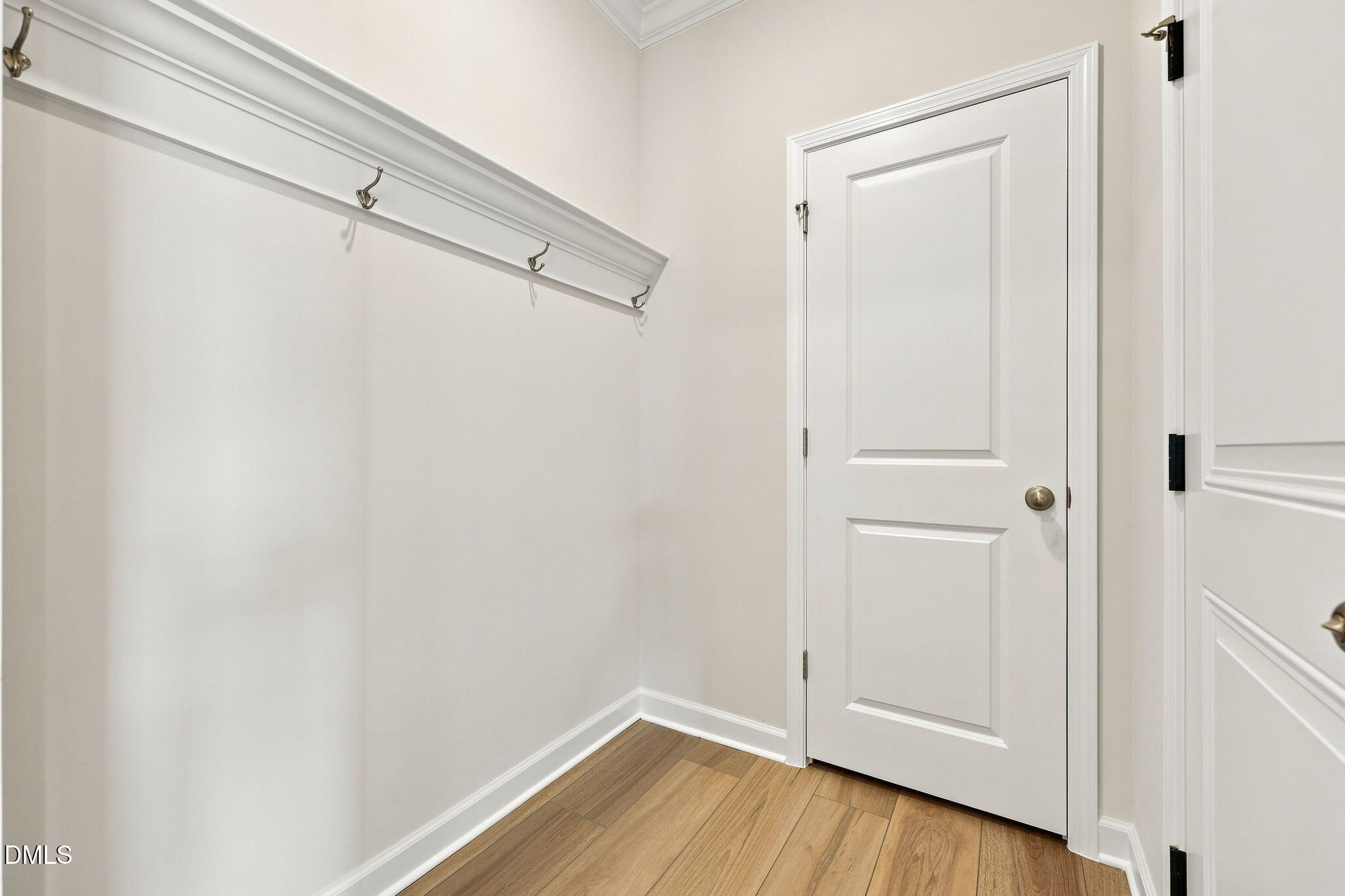 Mudroom area with coat hooks and hardwood floors in The Magnolia B floor plan at Retreat at North Main, Lillington, NC.