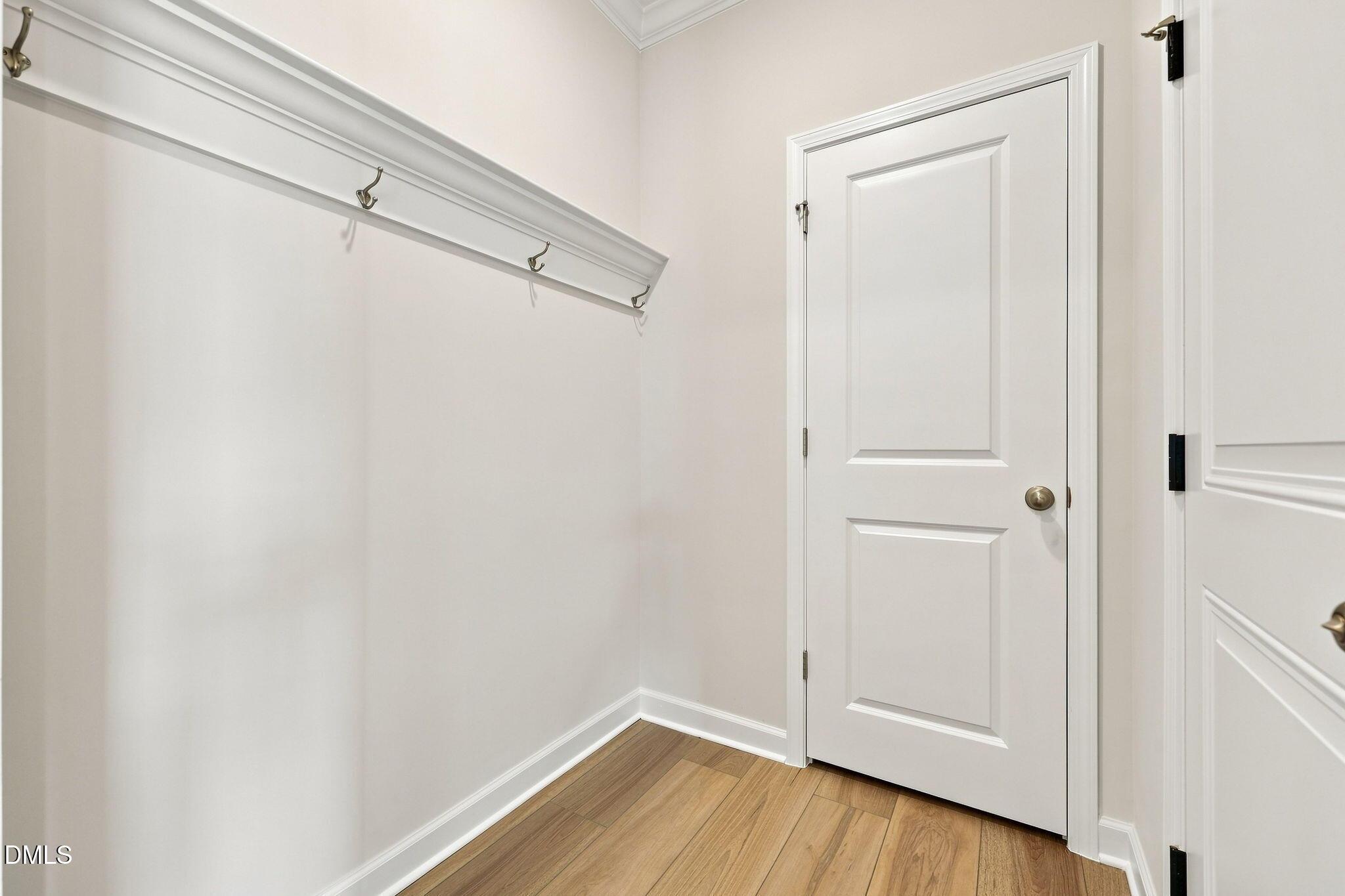 Mudroom area with coat hooks and hardwood floors in The Magnolia B floor plan at Retreat at North Main, Lillington, NC.