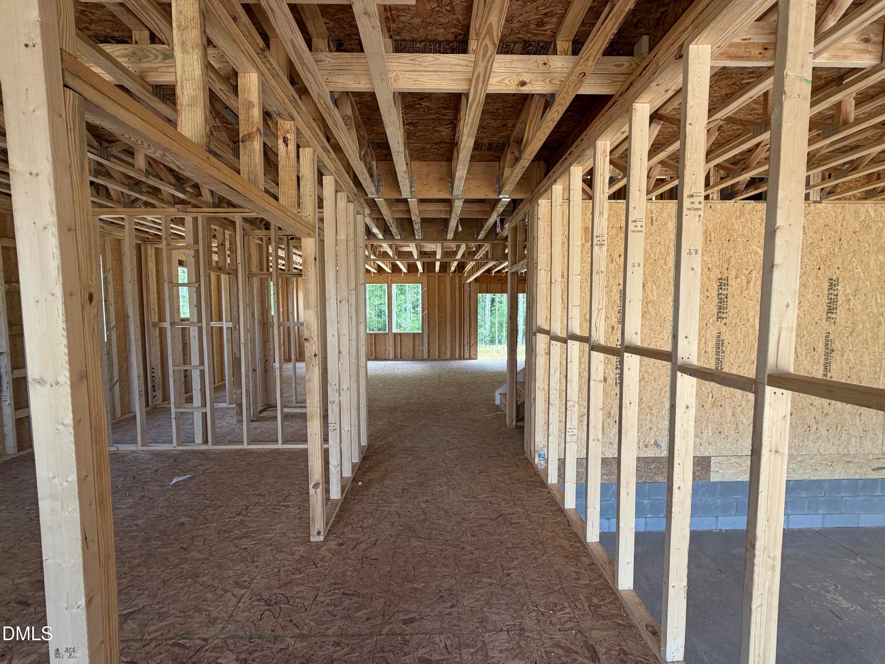 Exposed wooden framing with beams and plywood subfloor in open interior of The Hickory II C 4-bedroom home, Lillington, NC