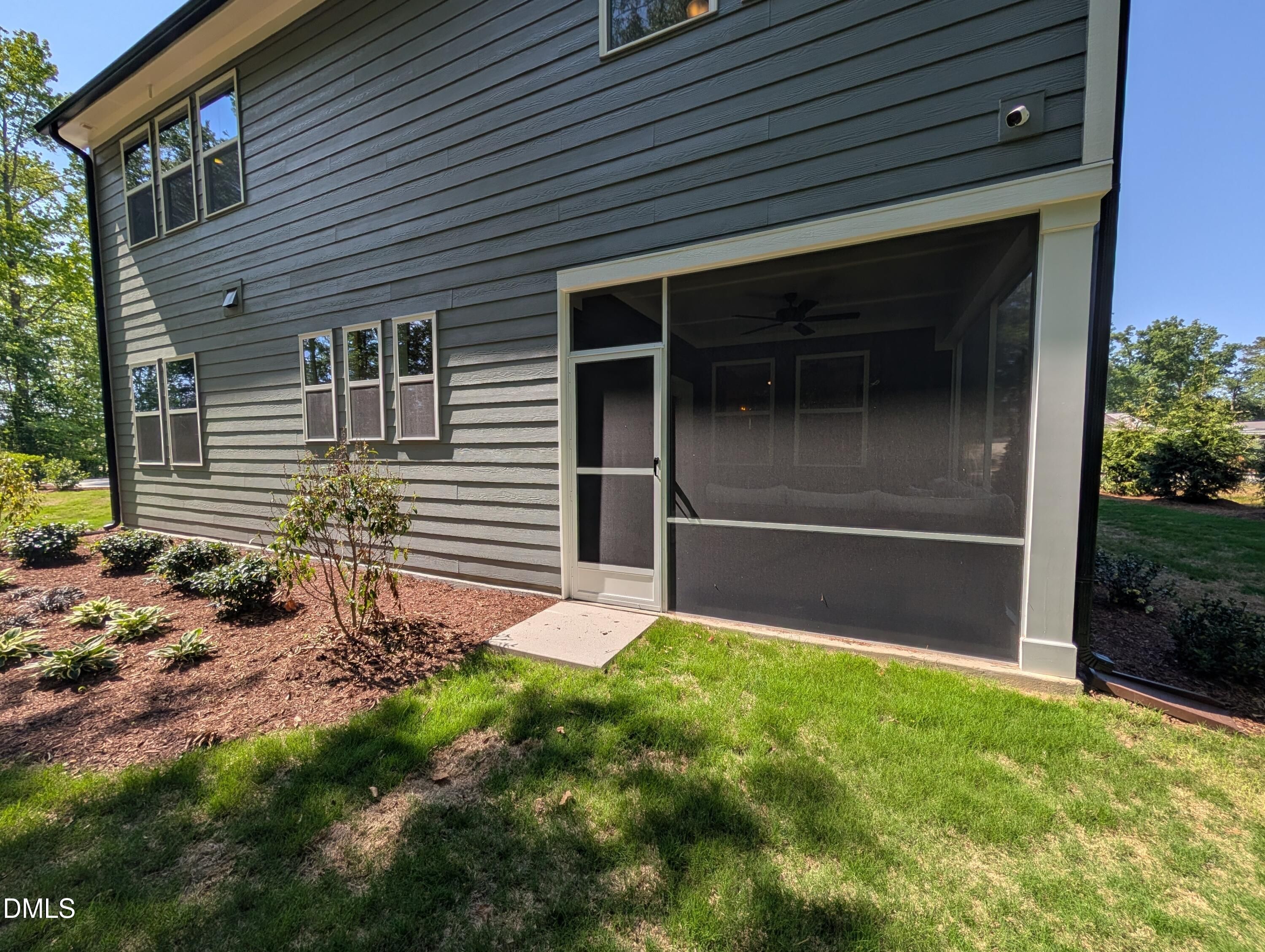 Screened-in porch with gray siding on The Aspen B floor plan at Wendell Ridge in Wendell, North Carolina.