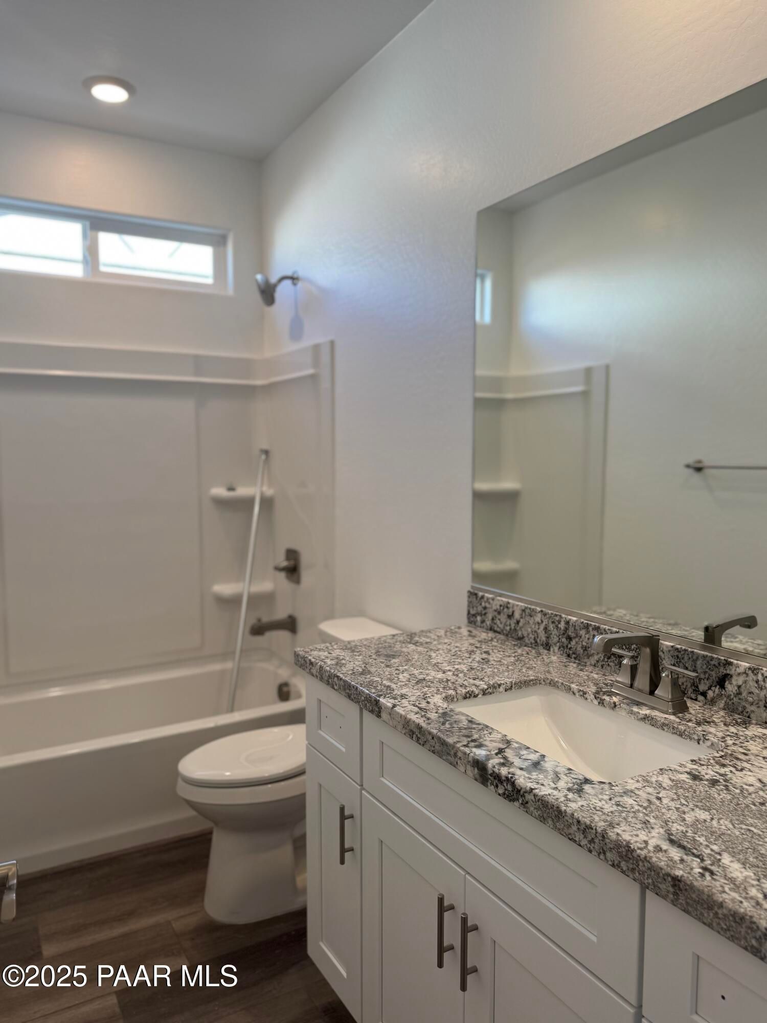 Modern bathroom with granite vanity, soaking tub, glass shower, and toilet in Davidson Homes The Sunrise II A, Prescott, Arizona