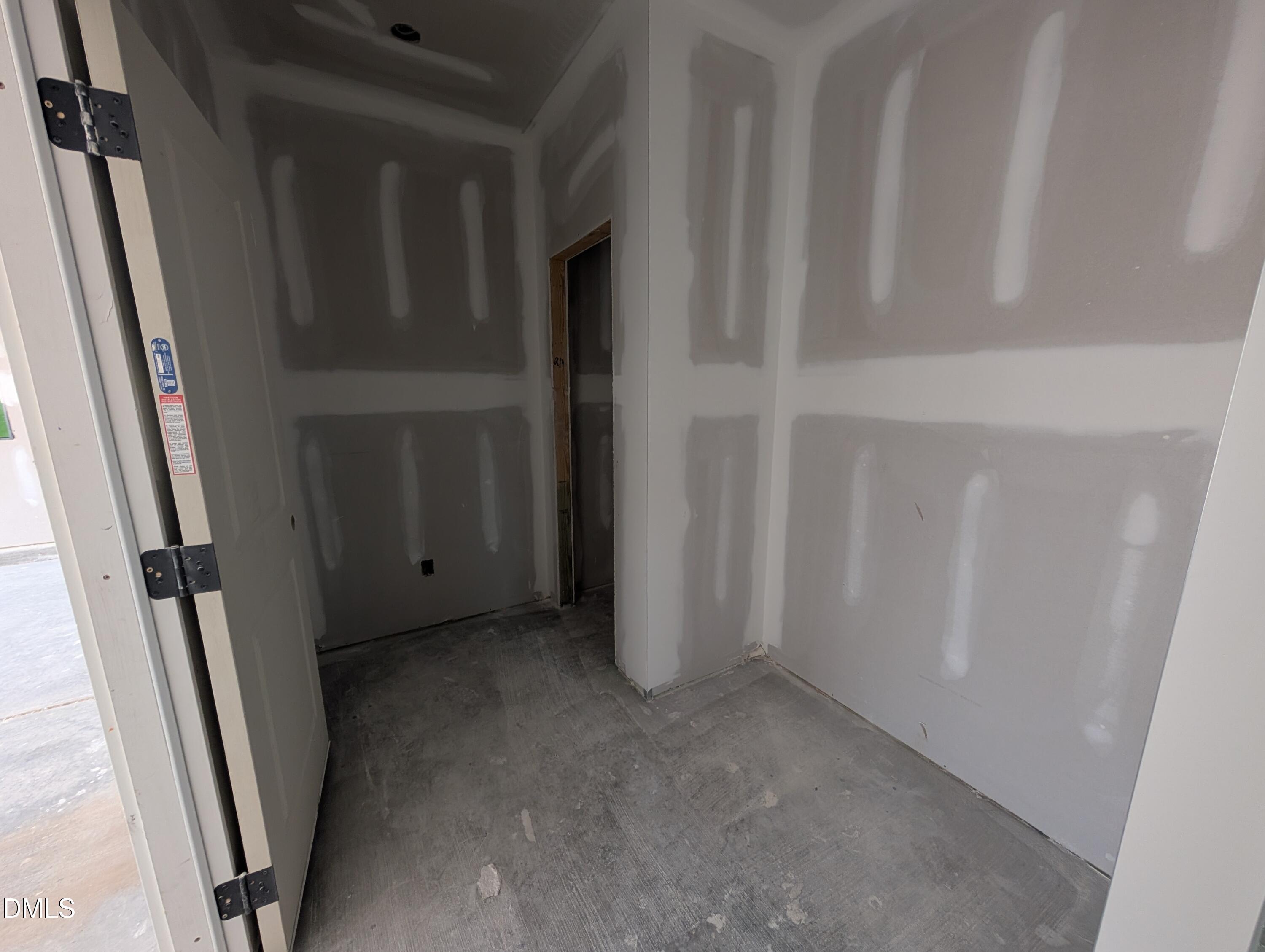 Unfinished drywall interior with taped seams and concrete floors in The Aspen C floor plan by Davidson Homes at Wendell Ridge, NC