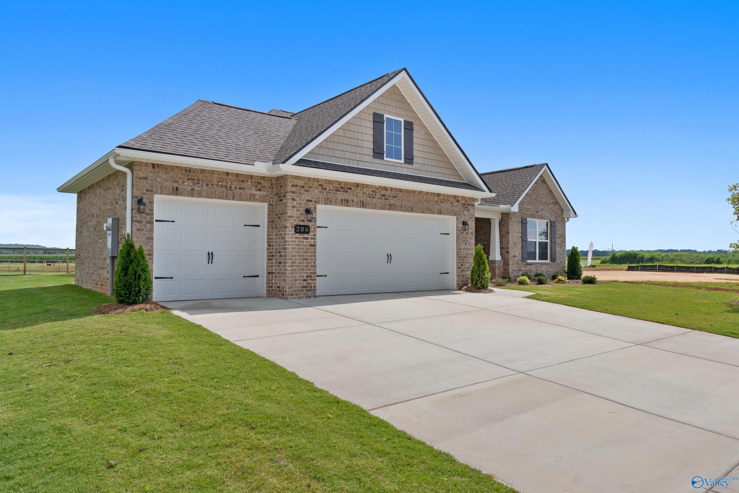 Brick 1-story home with 3-car garage, gabled roof, and landscaped driveway in Kendall Farms, Toney, Alabama - Davidson Homes Rockford B