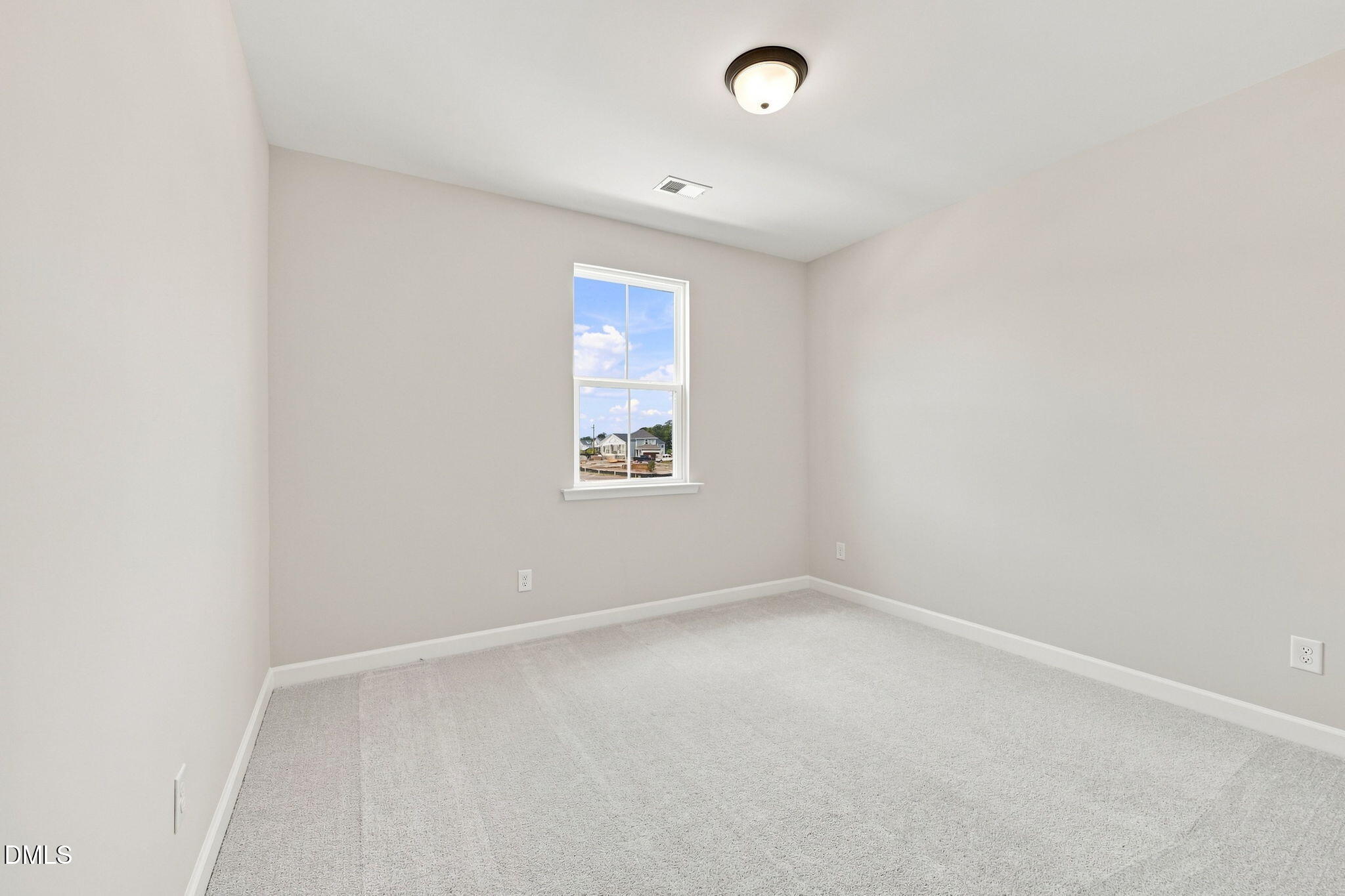 Bright, carpeted bedroom in The Harris C floor plan at Forestville Yard, Knightdale, North Carolina.