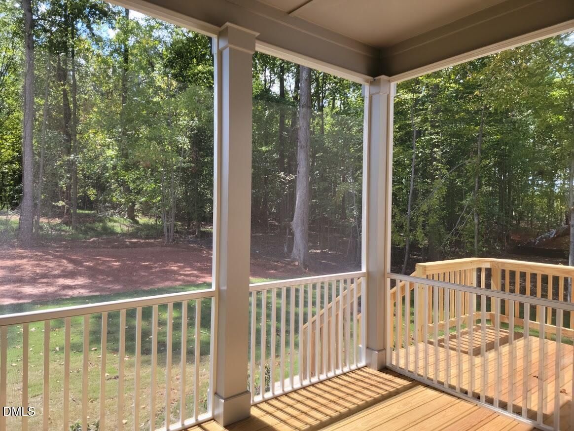 Screened porch with wooden deck overlooking wooded backyard in Davidson Homes The Crawford D plan, Rockport, Wake Forest, NC