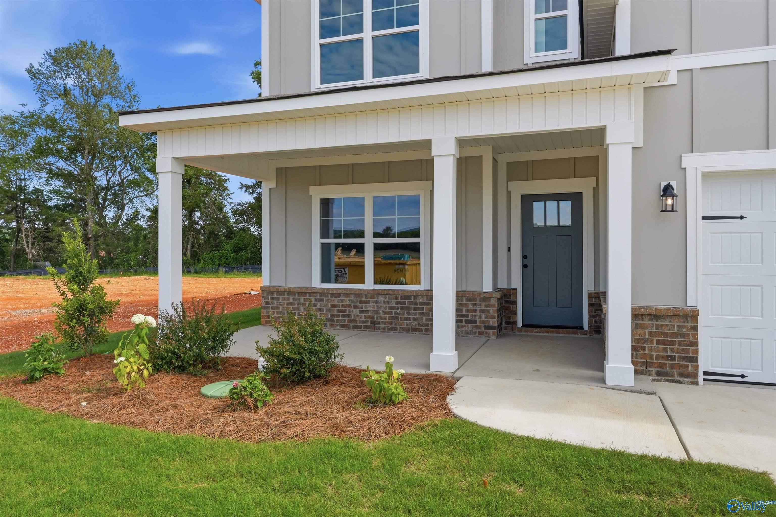 Covered front porch and entryway of The Chelsea D floor plan by Davidson Homes in Berry Cove, New Market, Alabama.