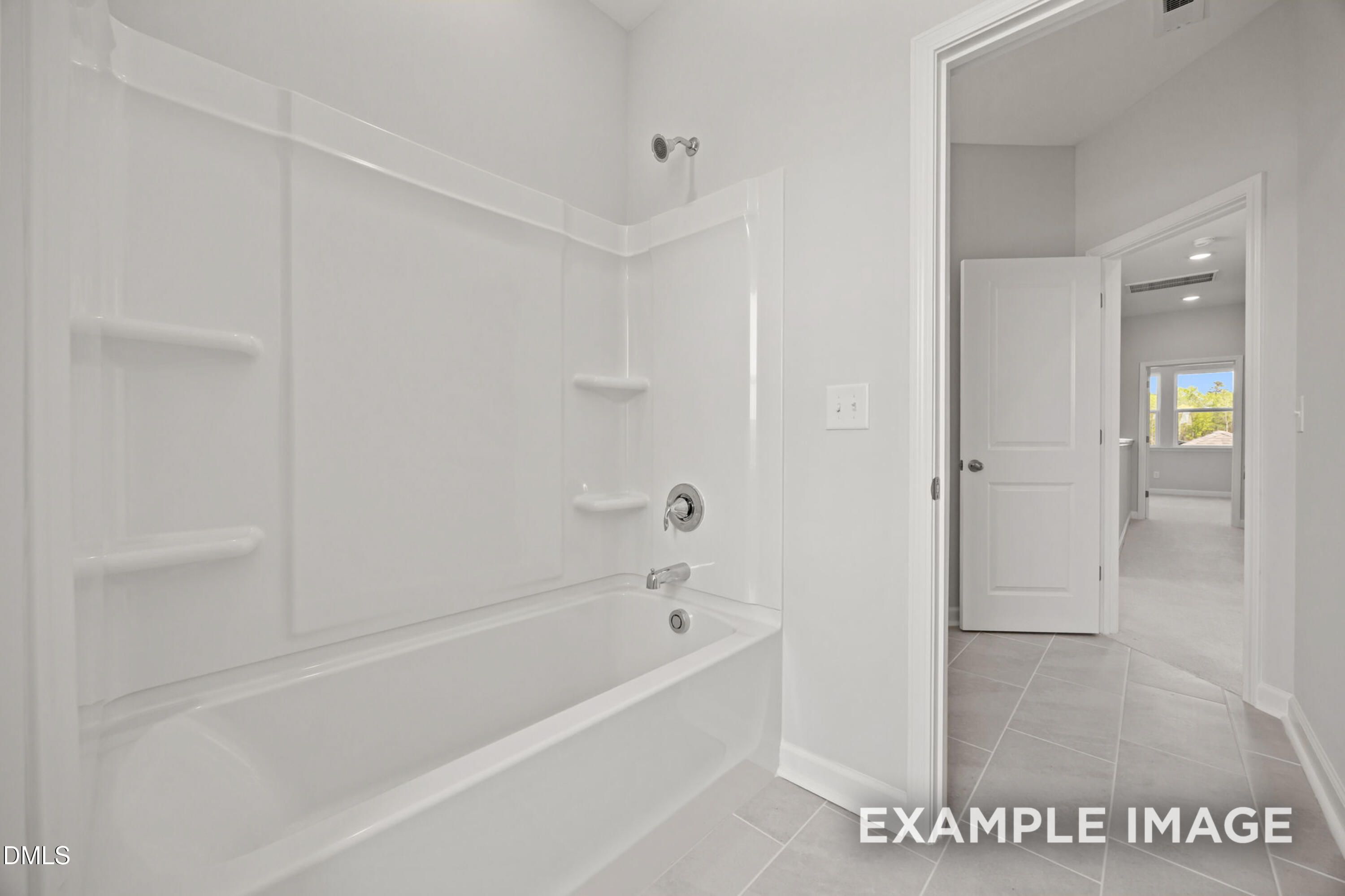 Modern bathroom with white tub-shower combo in The Alexander B floor plan at Forestville Yard in Knightdale, NC.