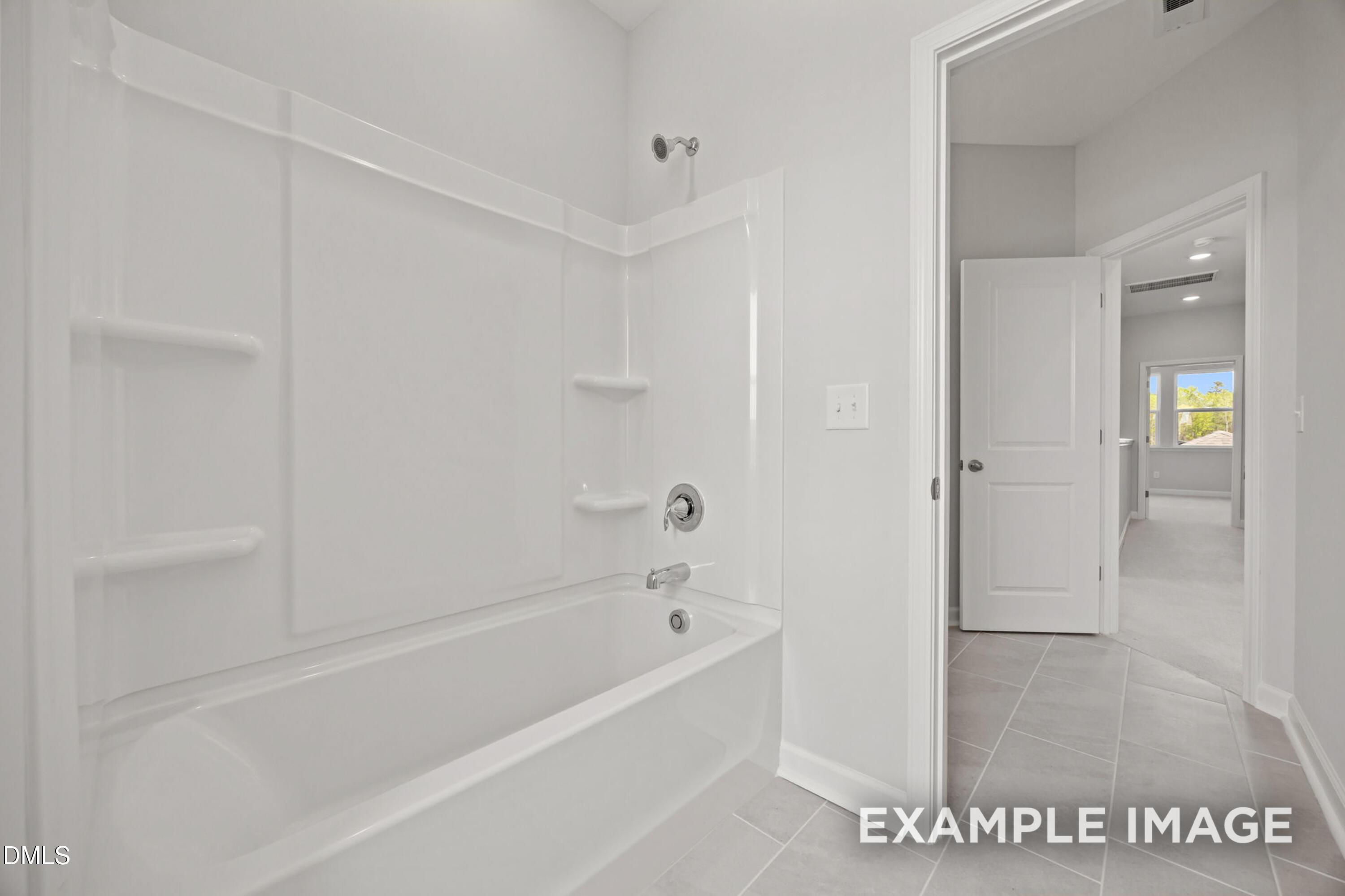 Modern bathroom with white tub-shower combo in The Alexander B floor plan at Forestville Yard in Knightdale, NC.