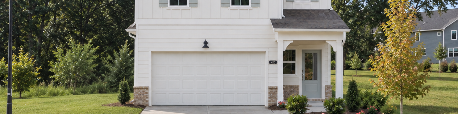 Modern white farmhouse exterior by Davidson Homes at Greene Farm in Cartersville, Georgia with two-car garage.